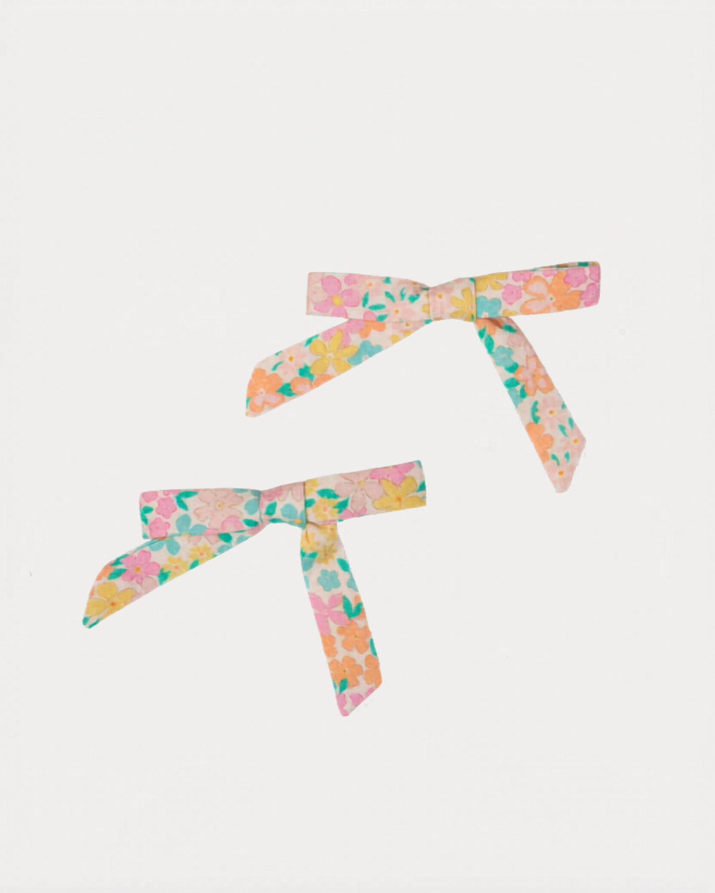 Early Sunday, Grace Clip in Emma Floral Mint color, made from Organic Printed Cotton Cambric fabric, featuring a set of two bow clips with a secure fit, shown in front flat-lay view
