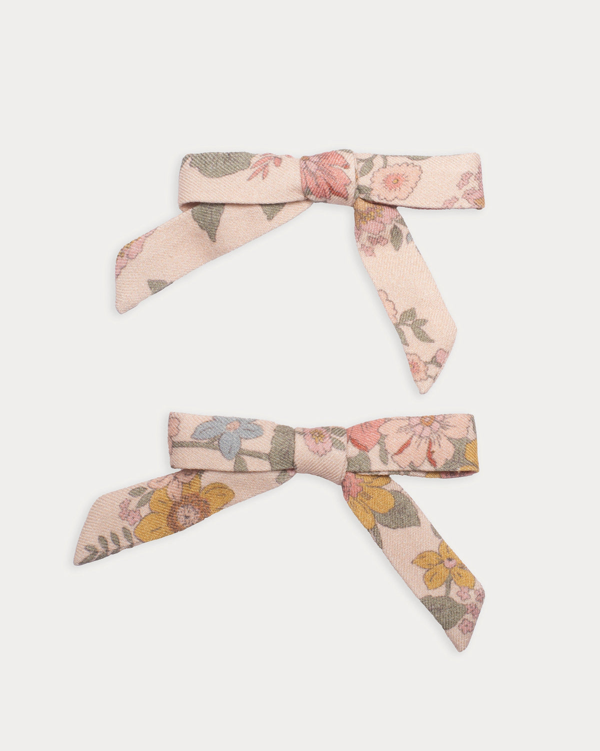 Early Sunday, Grace Clip in Bloom Blush, made from Printed Viscose Twill fabric, featuring a set of two bow clips with a secure fit, shown in a front flat-lay view