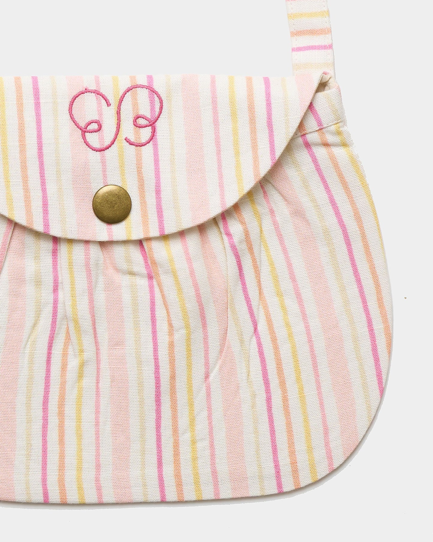Early Sunday, Hudson Purse in Pink Stripes print, made from 70% Cotton, 30% Linen fabric, featuring a gathered sling purse design with a flap closure, shown in a closeup flat-lay view