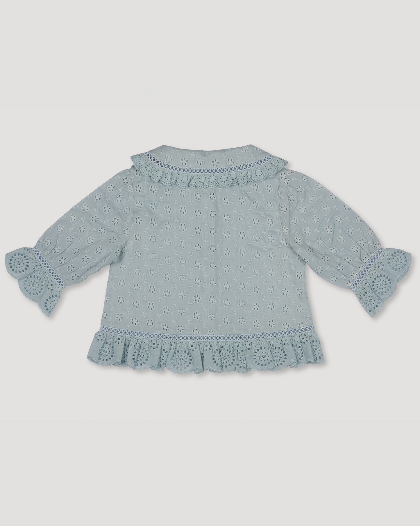 Early Sunday, Iris Blouse in Sea Dream color, made from All-Over Eyelet Embroidered Cotton Schifflie fabric, featuring relaxed fit with delicate detailing for a timeless and feminine look, shown in a back flat-lay view