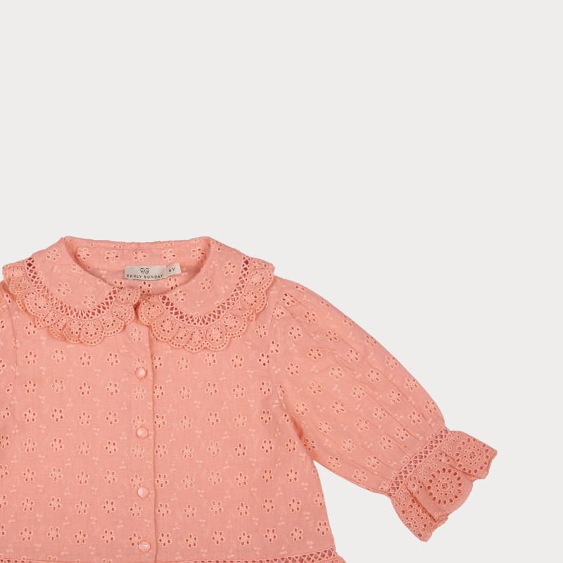 Early Sunday, Iris Blouse in Strawberry color, made from All-Over Eyelet Embroidered Cotton Schifflie fabric, featuring relaxed fit with delicate detailing for a timeless and feminine look, shown in a closeup flat-lay view