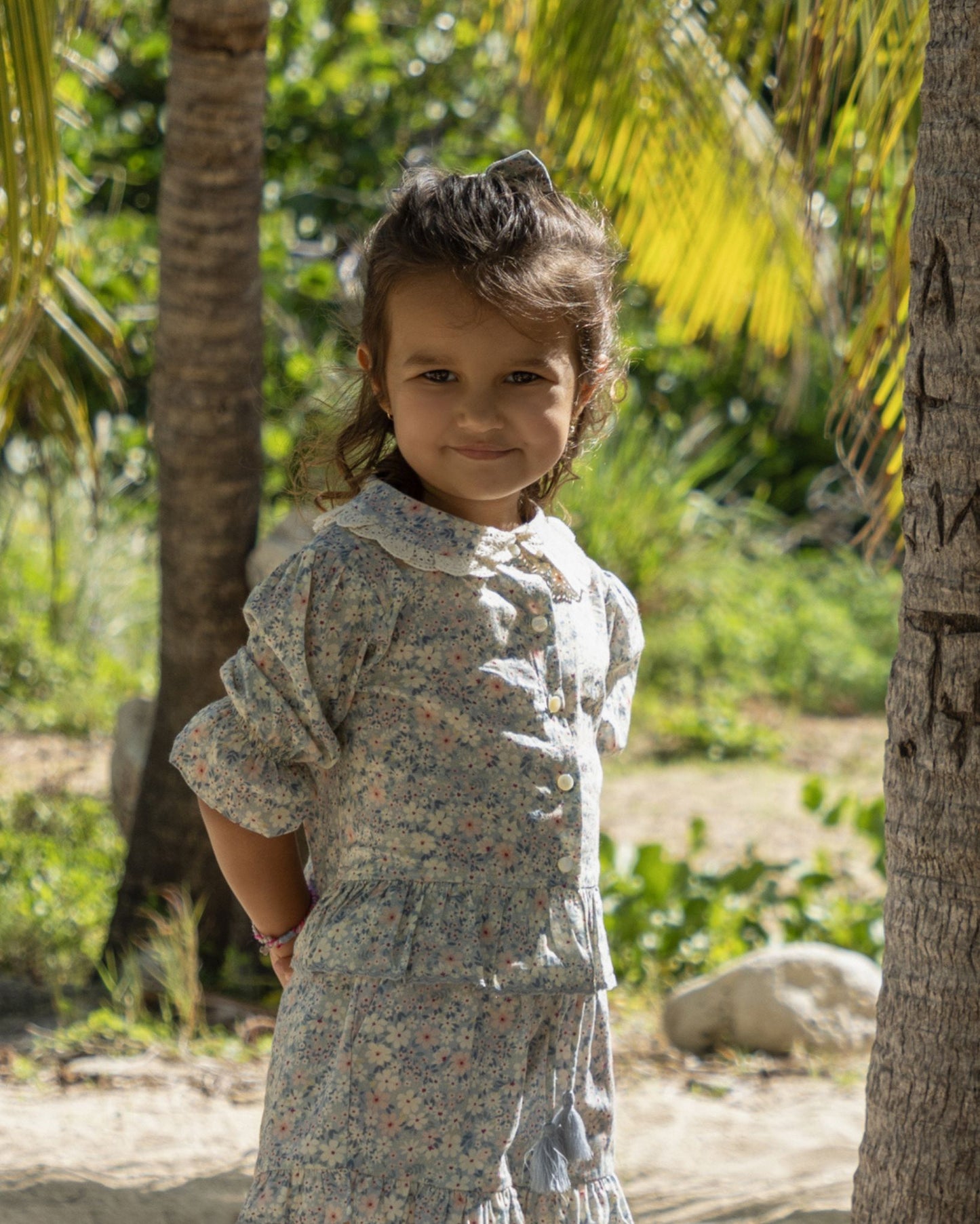 Early Sunday, Iris Blouse in Amelia print, made from Printed Cotton Cambric fabric, featuring relaxed fit with delicate detailing for a timeless and feminine look, shown in a close-up side view of a model wearing it