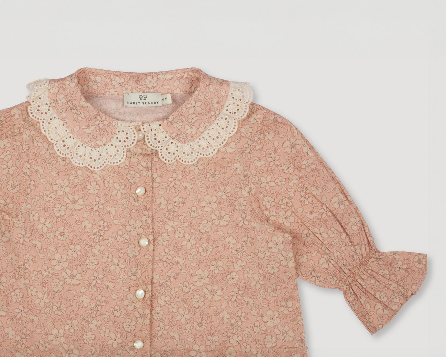 Early Sunday, Iris Blouse in Garden Flowers print, made from Printed Cotton Cambric fabric, featuring relaxed fit with delicate detailing for a timeless and feminine look, shown in a closeup flat-lay view