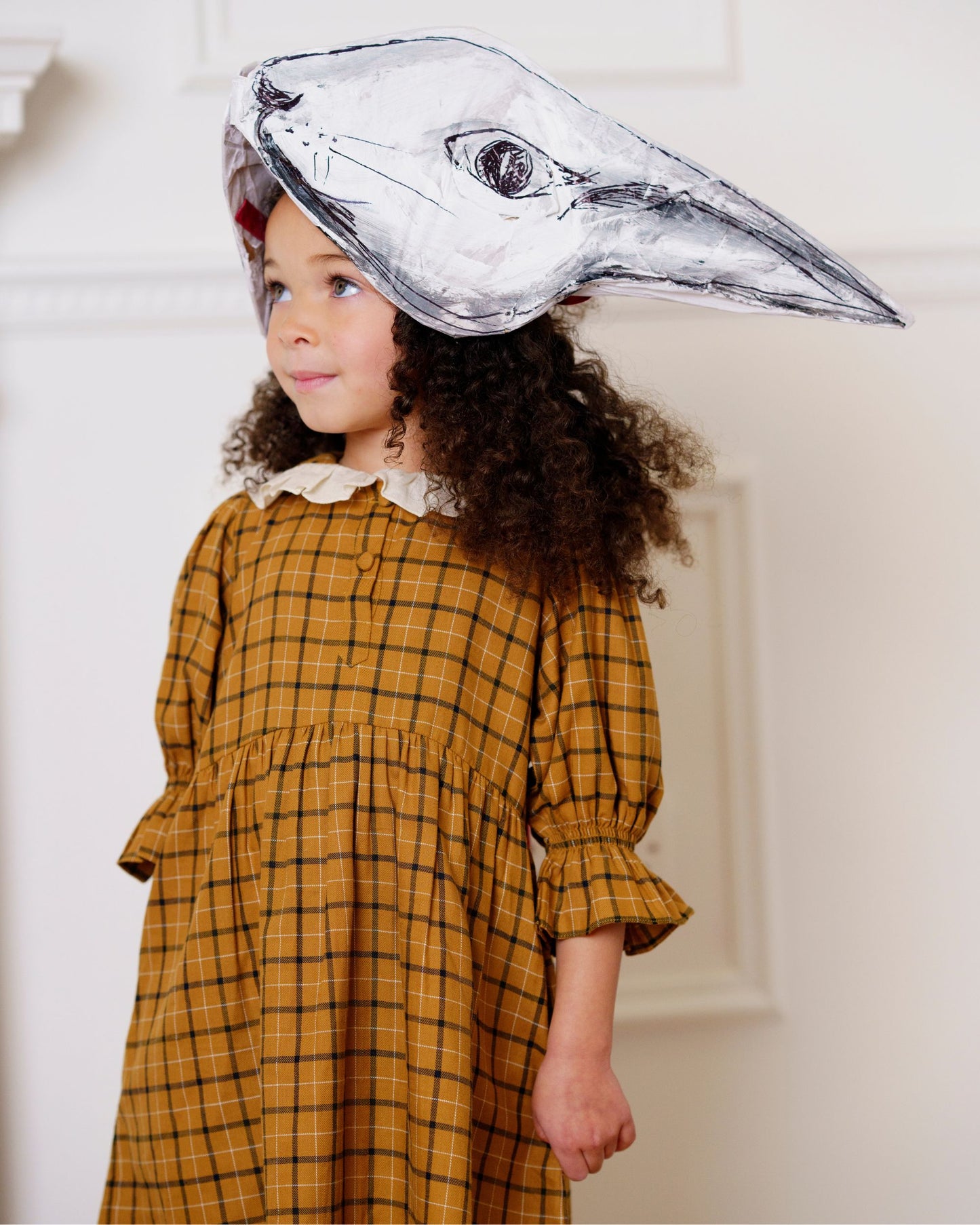 Early Sunday, Jacky Dress in Almond Checks, made from Cotton Yarn Dyed Brushed Checks fabric, featuring White contrast scallop-edge collar adds a sweet vintage touch, shown in a close-up shot of a model wearing it during a studio shoot