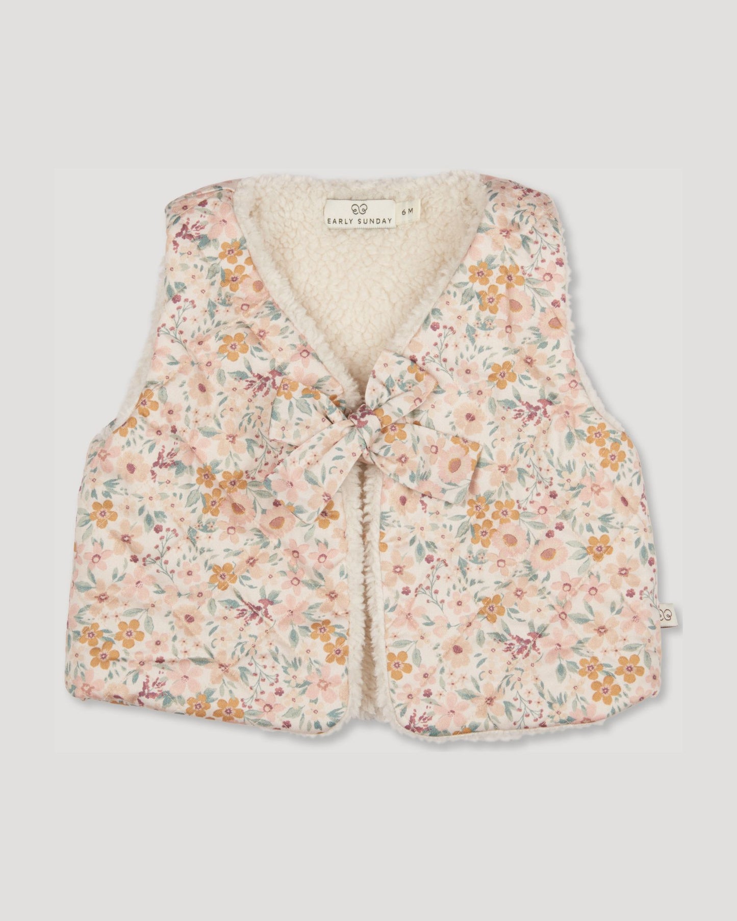 Early Sunday, Jilly Gilet in Floral print, made from Printed 60s Cotton Satin fabric, featuring a sleeveless gilet design with soft padding, shown in a front flat-lay view