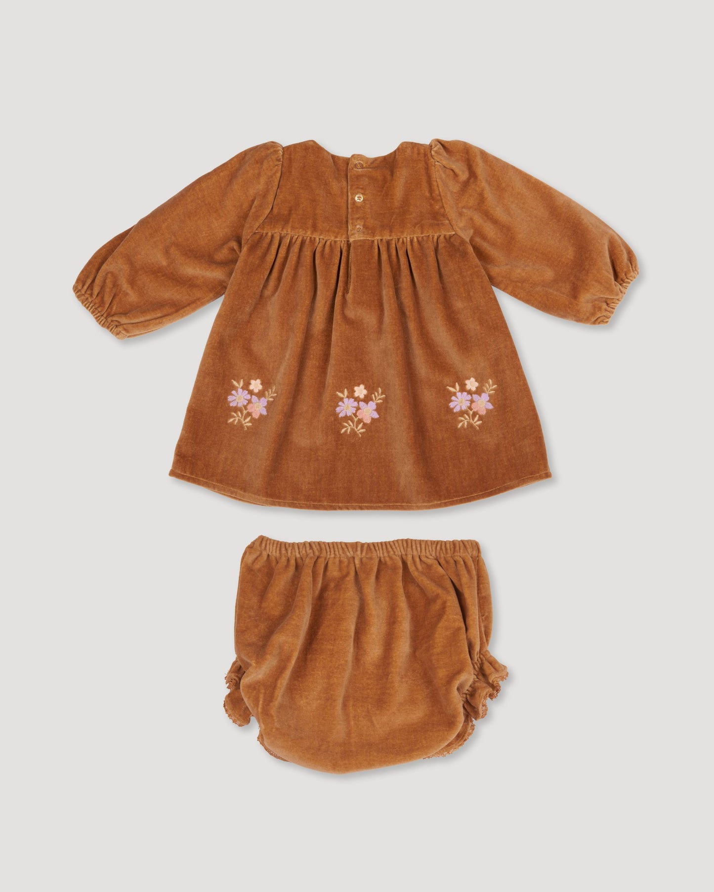 Early Sunday, Joni Baby Dress & Bloomer Set in Almond color, made from Dyed Cotton Velvet fabric, featuring long puff sleeves & gathered waist with matching bloomers, shown in a back flat-lay view
