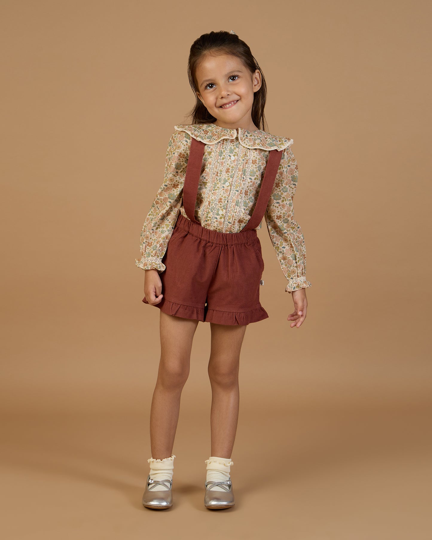 Early Sunday, Joseph Short Dungaree in Caramel, made from Cotton Corduroy fabric, featuring short dungaree with adjustable straps, shown in a front view of a model wearing it in a studio setting