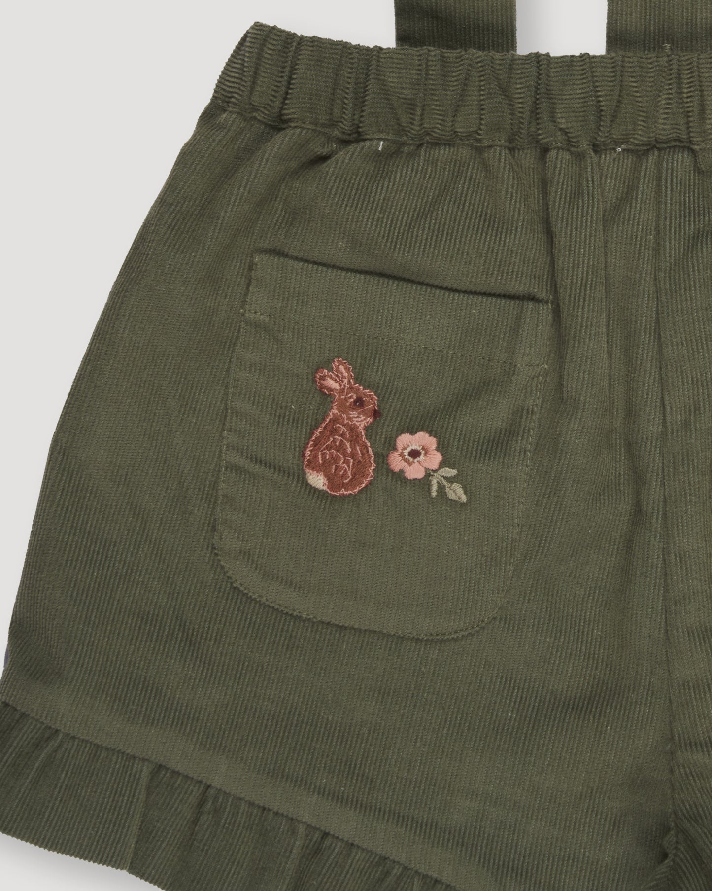 Early Sunday, Joseph Short Dungaree in Moss, made from Cotton Corduroy fabric, featuring short dungaree with adjustable straps, shown in a closeup flat-lay view