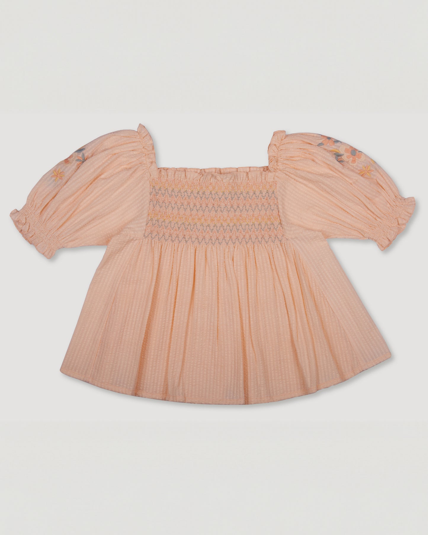 Early Sunday, Judith Blouse in Warm Sand color, made from Cotton Seersucker fabric, featuring relaxed fit with delicate finishes, combining style and functionality, shown in a back flat-lay view