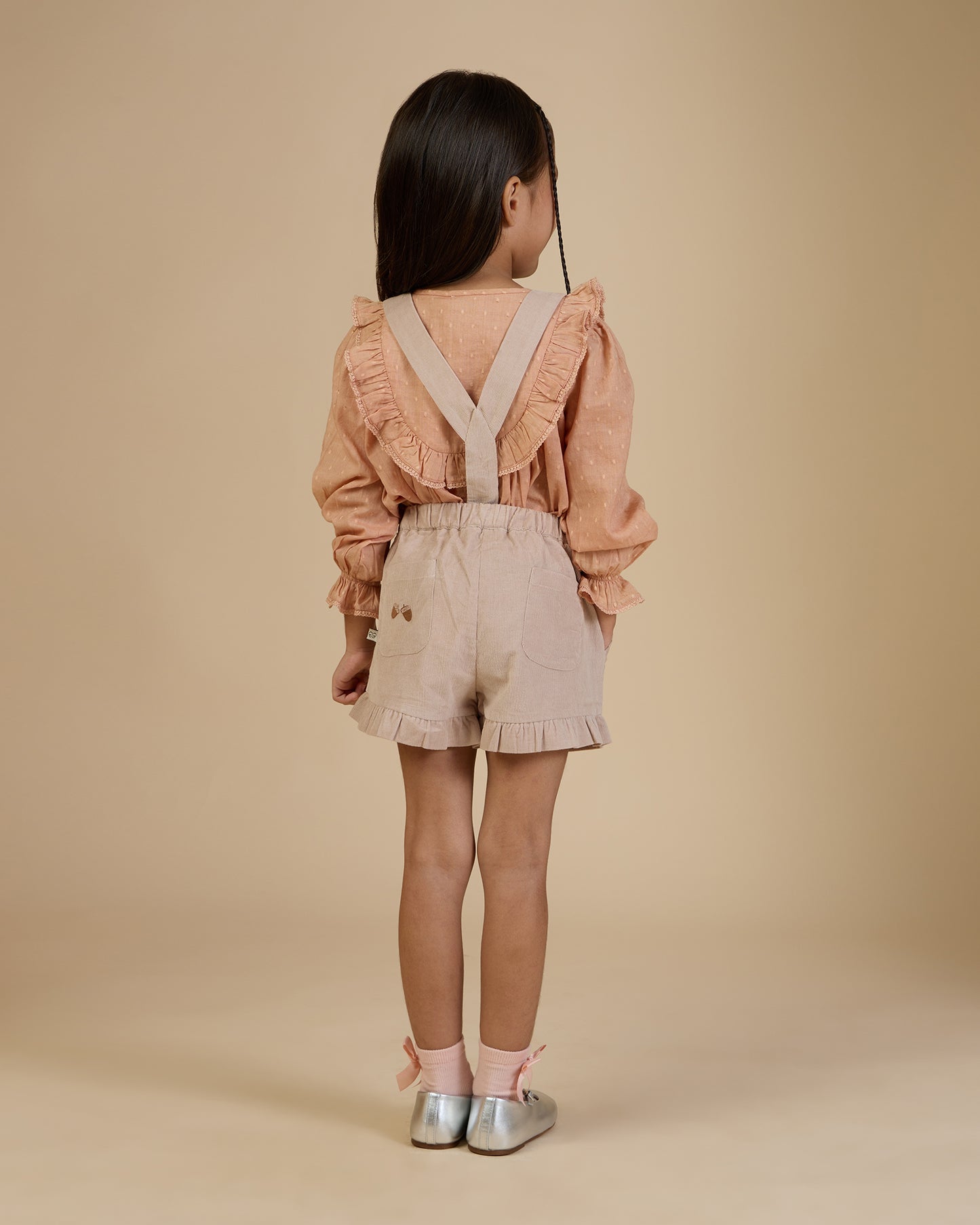 Early Sunday, Lauren Blouse in Earthy Pink, made from Cotton Swiss Dobby fabric, featuring relaxed fit with a floral embroidered yoke, shown in a back view of model wearing it