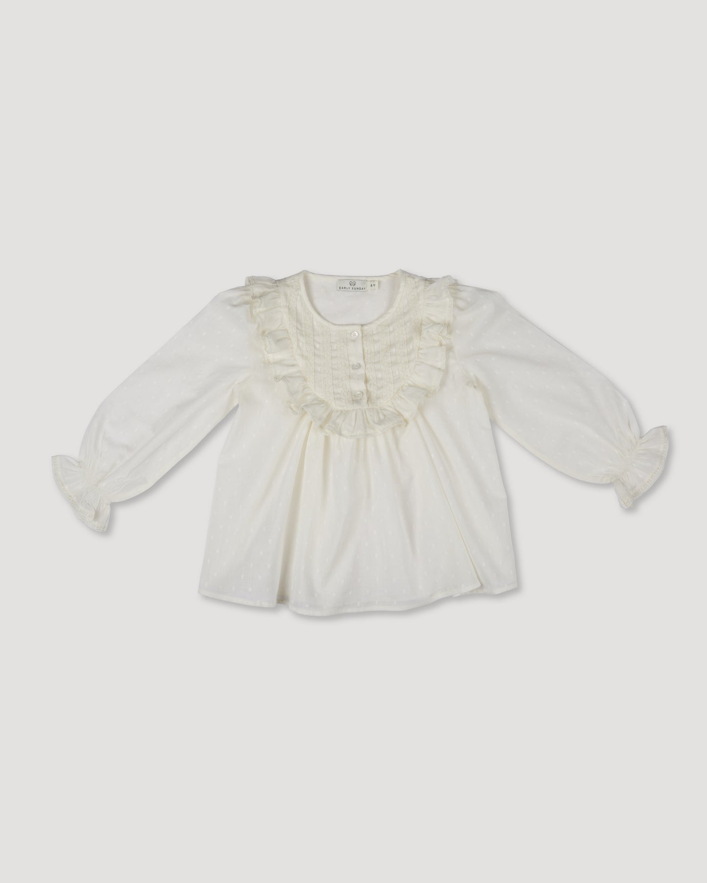 Early Sunday, Lauren Blouse in Ecru, made from Cotton Swiss Dobby fabric, featuring relaxed fit with a floral embroidered yoke, shown in a front flat-lay view
