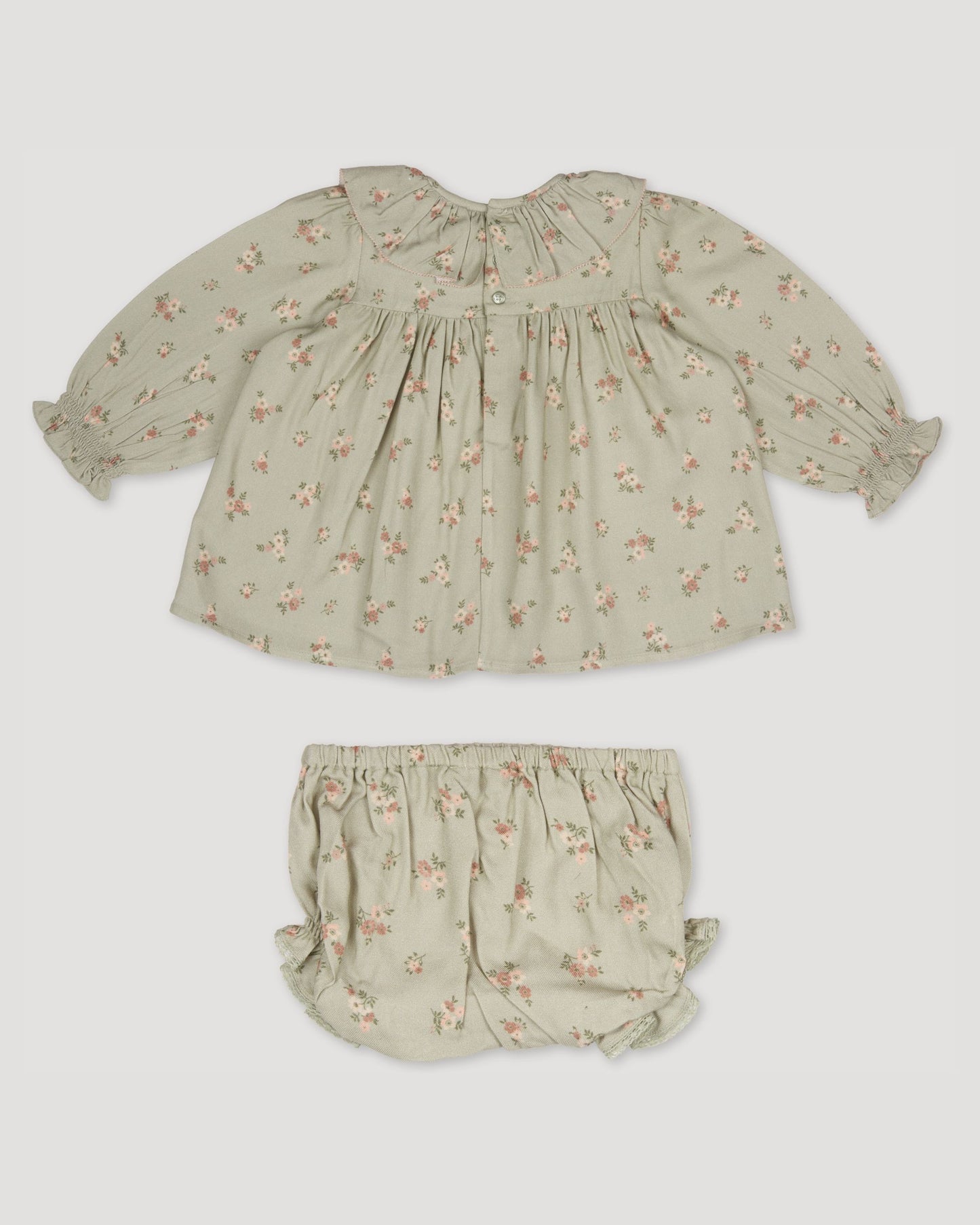 Early Sunday, Libby Baby Dress & Bloomer Set in Ditsy Bouquet Jade print, made from Printed Viscose Rayon Twill fabric, featuring long sleeves with frilly neck & floral print, shown in a back flat-lay view