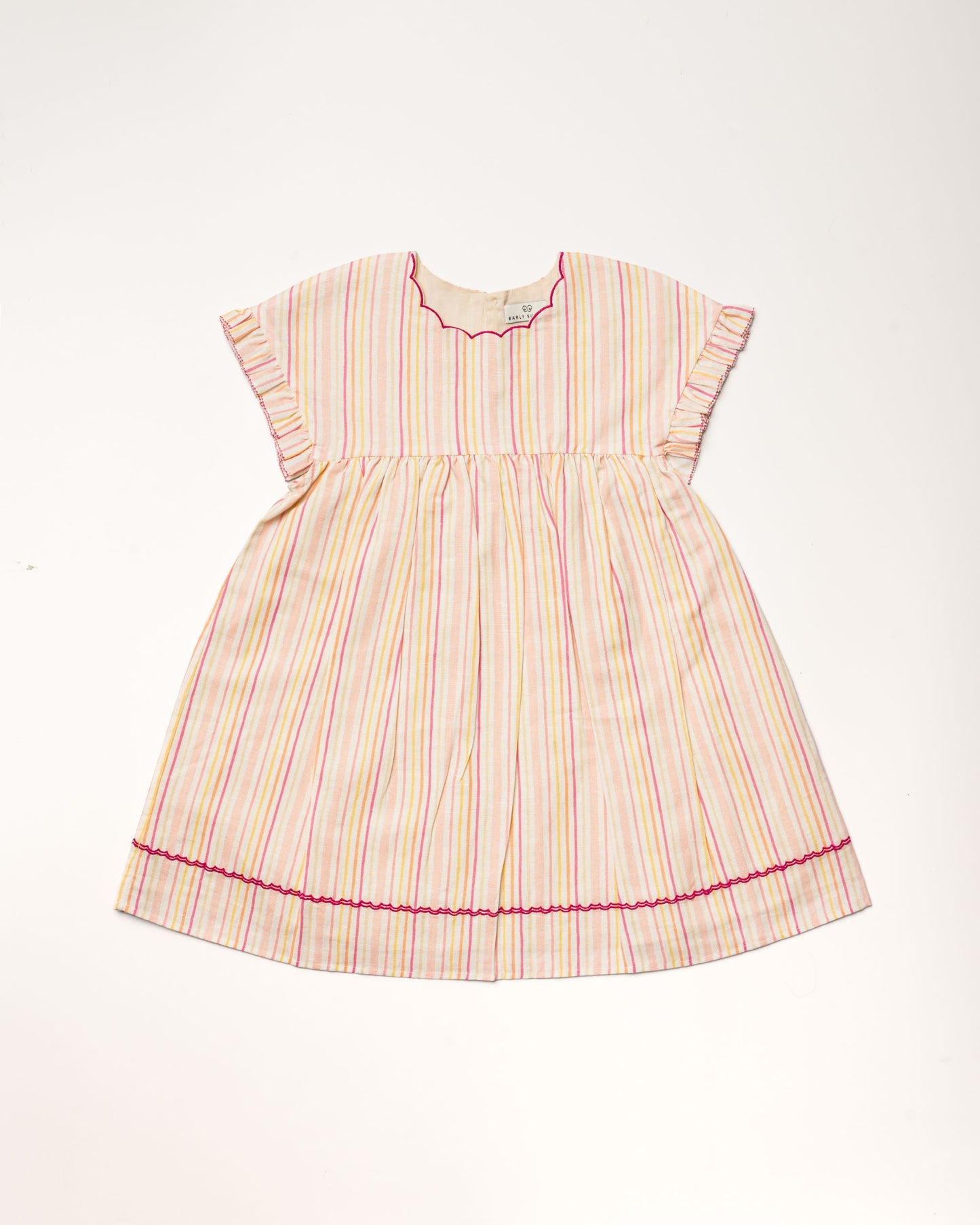 Early Sunday, Lila Dress in Pink Stripes color, made from printed 70% cotton 30% linen fabric, featuring Scalloped neckline with contrast stitching, flutter sleeves, gentle gathers, and embroidered hem detail, shown in a front flat-lay view