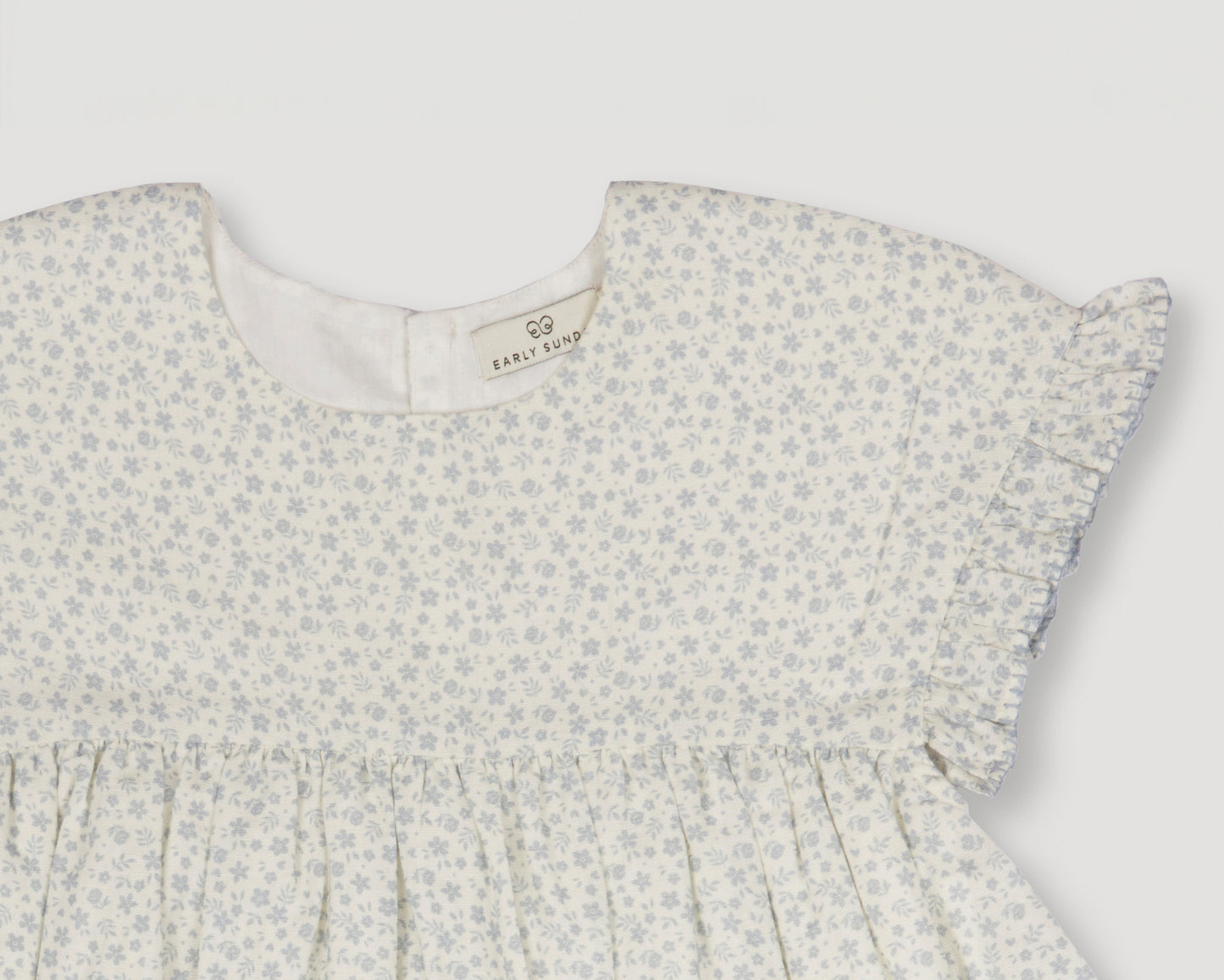 Early Sunday, Lila Dress in Mini Flower print, made from Printed canvas 70% Cotton 30% Linen fabric, featuring a flattering mini dress with a relaxed fit, designed for comfort and effortless style, shown in a closeup flat-lay view