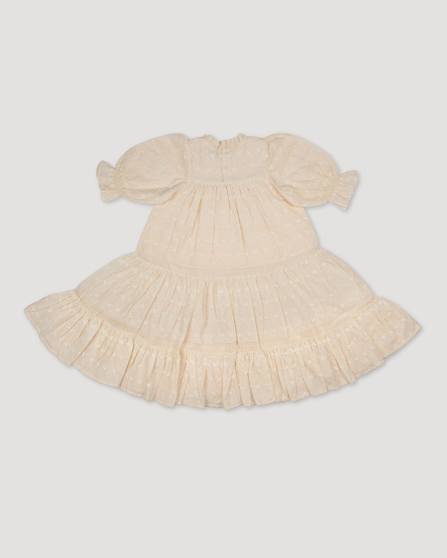 Early Sunday, Lilly Dress in Hazelnut Cream, made from All-Over Embroidered Cotton Cambric fabric, featuring Delicate floral embroidery placed softly across the dress for a timeless, heirloom-inspired finish, shown in a back flat-lay view