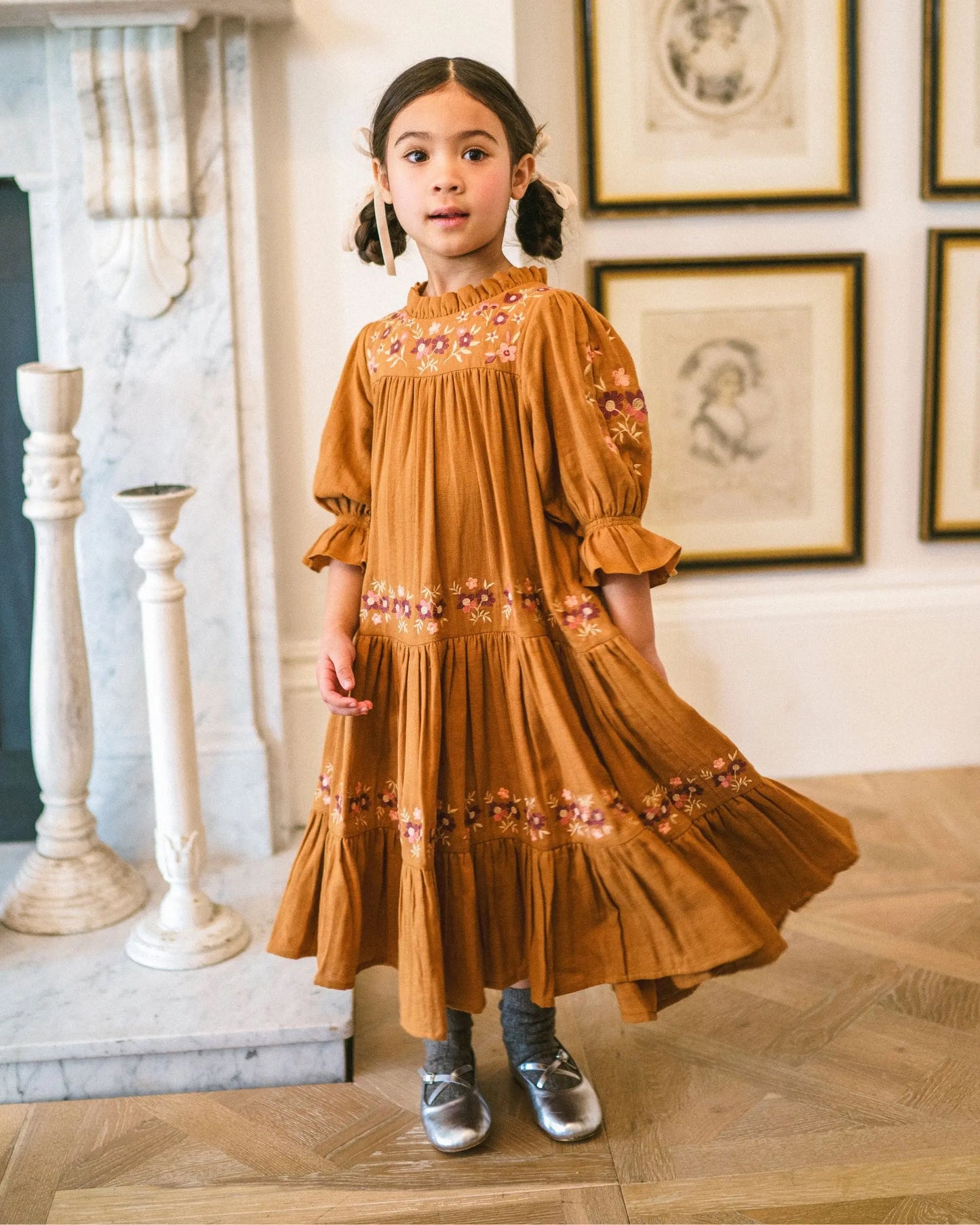 Early Sunday, Lilly Dress in Almond, made from Dyed Cotton Double Gauze fabric, featuring Delicate floral embroidery placed softly across the dress for a timeless, heirloom-inspired finish, shown in a front view of a model wearing it in a studio setting