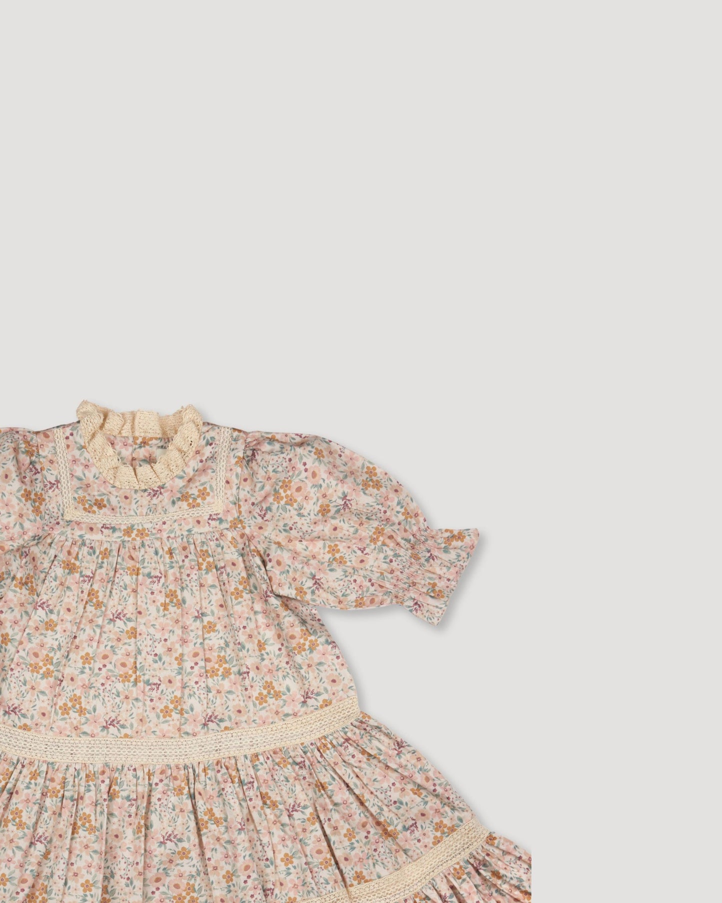 Early Sunday, Lilly Dress in Floral print, made from Printed Cotton Satin fabric, featuring Delicate floral embroidery placed softly across the dress for a timeless, heirloom-inspired finish, shown in a closeup flat-lay view