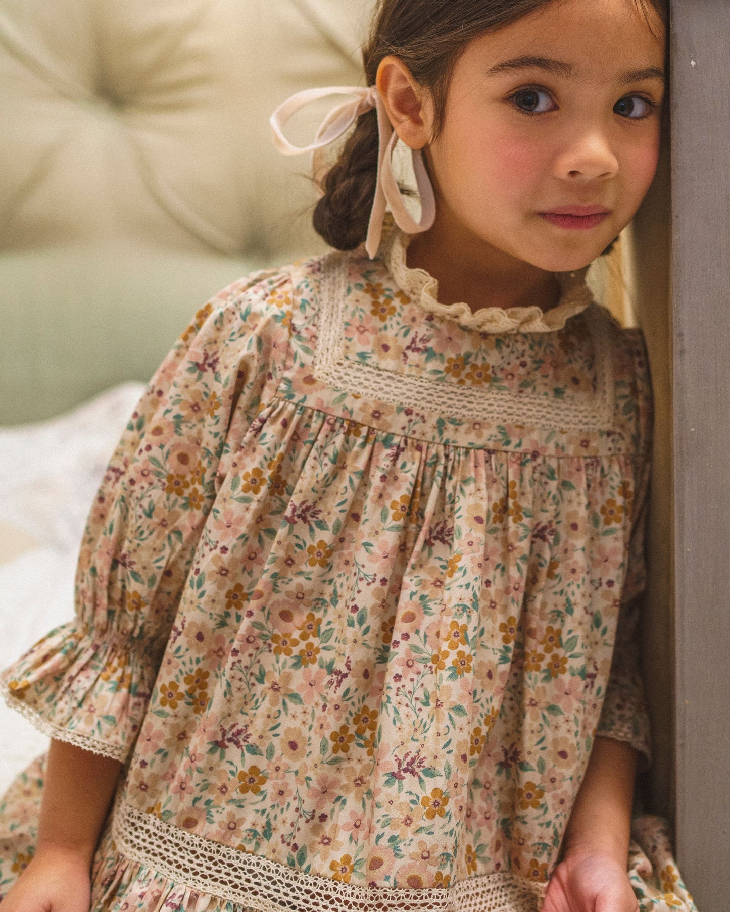 Early Sunday, Lilly Dress in Floral print, made from Printed Cotton Satin fabric, featuring Delicate floral embroidery placed softly across the dress for a timeless, heirloom-inspired finish, shown in a close up shot of model wearing it