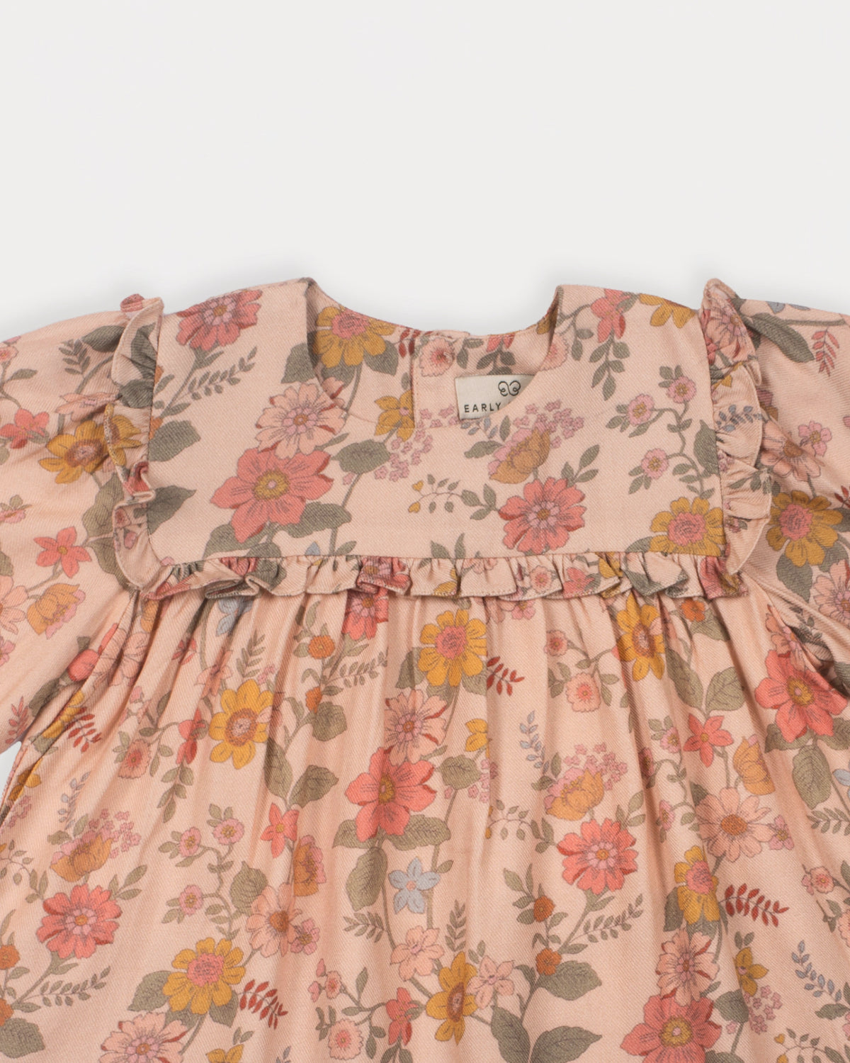 Early Sunday, Lottie Baby Dress & Bloomer Set in Bloom, made from Printed Viscose Twill fabric, featuring a frilly neckline & squared frills around the chest, shown in a closeup flat-lay view