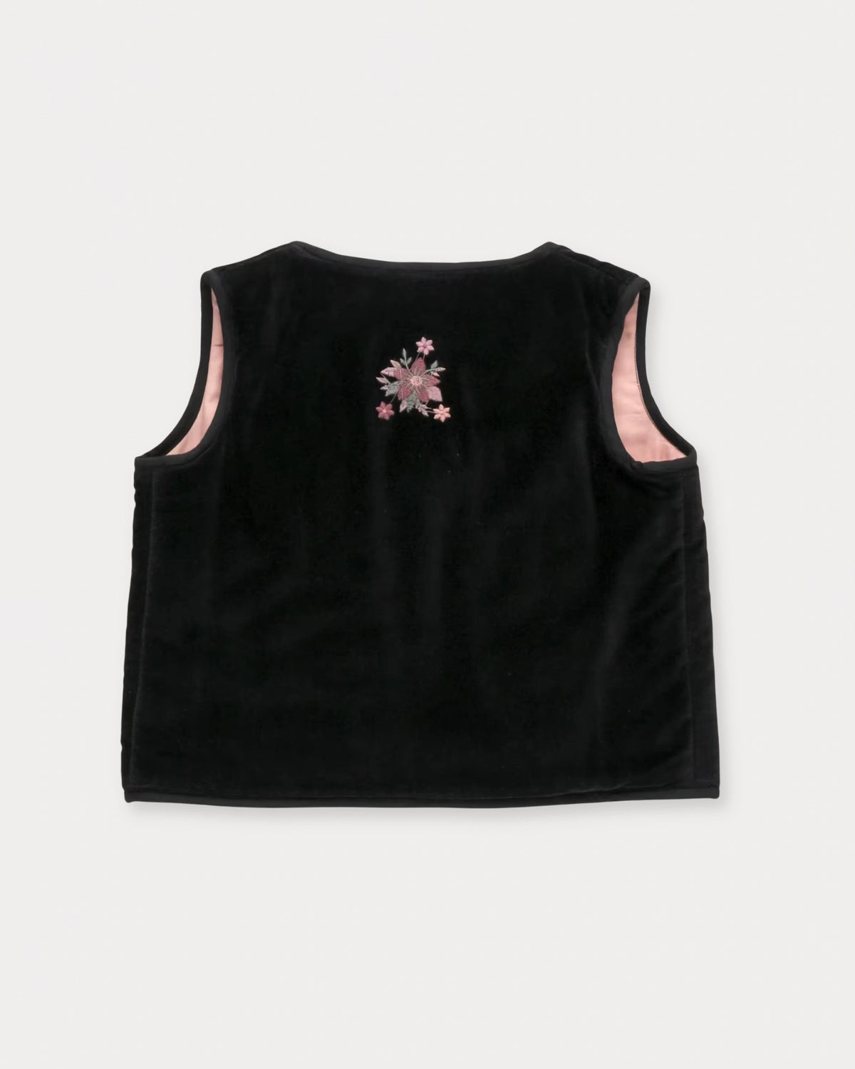 Early Sunday, Lou Vest jacket in Black, made from Cotton Velvet Velour's fabric, featuring sleeveless quilted silhouette with tie-up bow and floral embroidery, shown in a back flat-lay view
