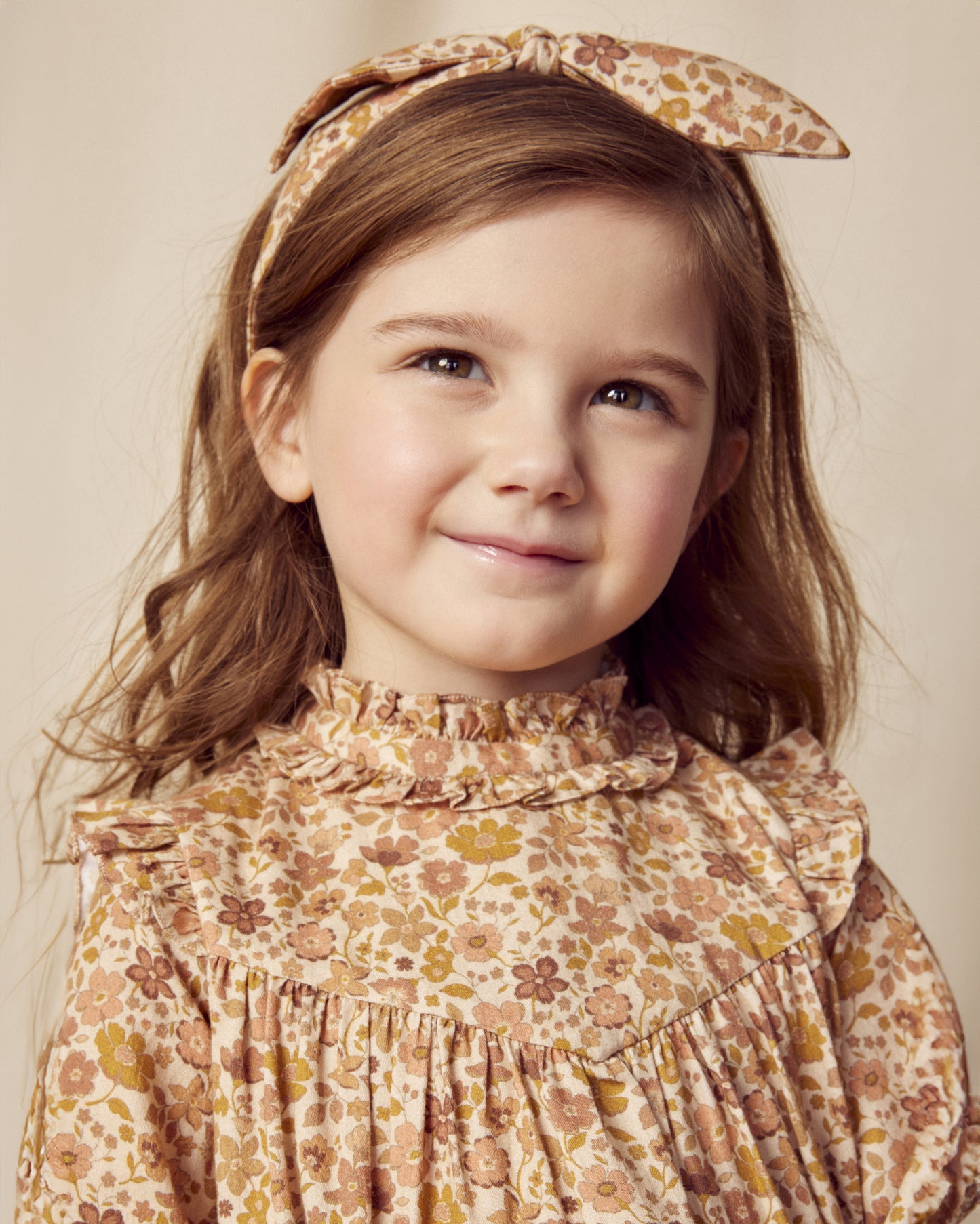 Early Sunday, Louise Dress in Garden Flowers Dusty Pink, made from Printed Cotton Satin fabric, featuring classic silhouette with a charming print, shown in a close up shot of model wearing it
