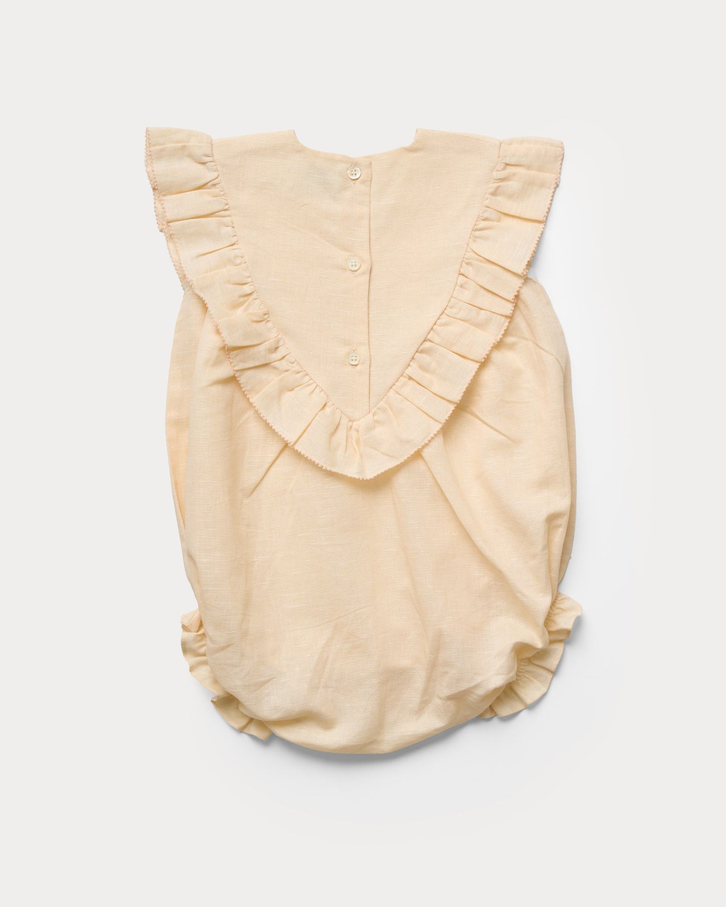 Early Sunday, Lucy Baby Bubble Romper in Sand color, made from 70% Cotton 30% Linen fabric, featuring a bubble pattern with beautiful embroidery, shown in a back flat-lay view