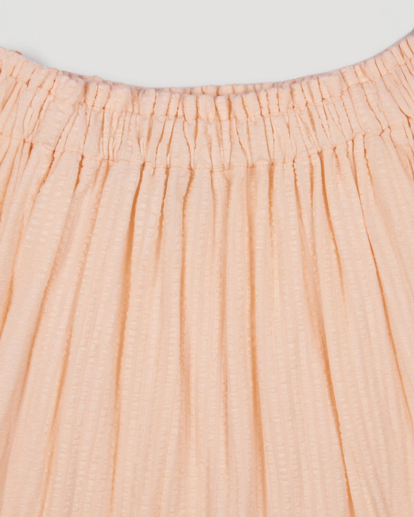 Early Sunday, Luna Skirt in Warm Sand color, made from Cotton Seersucker fabric, featuring flattering silhouette with an easy fit, combining style and comfort, shown in a close-up of print