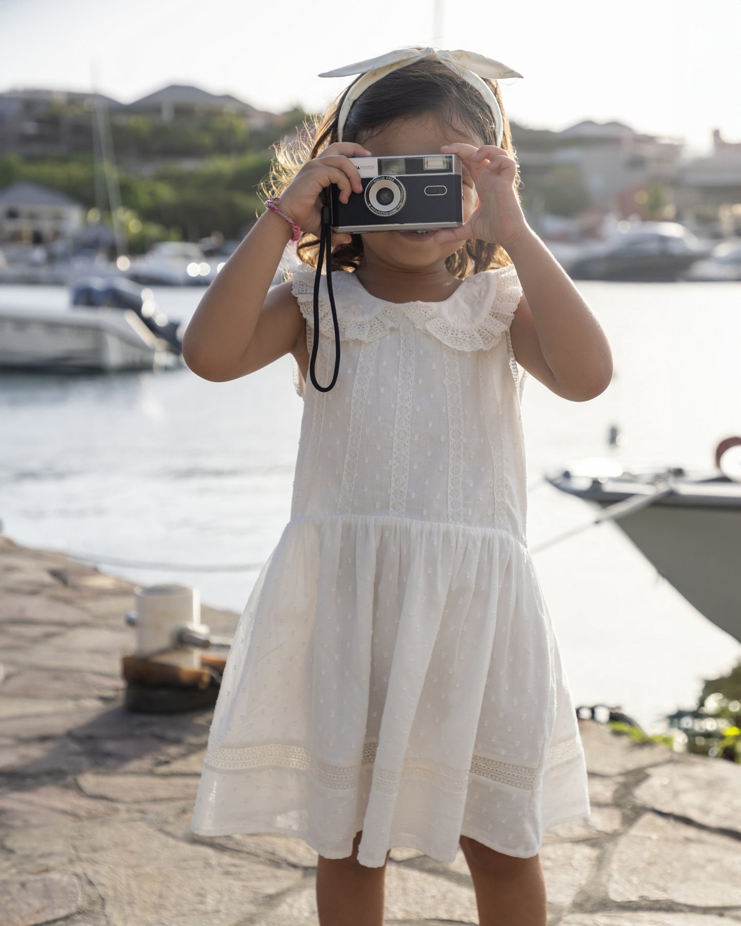 Early Sunday, LYS Dress in Ivory color, made from Cotton Dobby Swiss Dots fabric, featuring flattering fit with delicate finishes, combining style and functionality for an effortlessly elegant look, shown in a front view of model wearing it