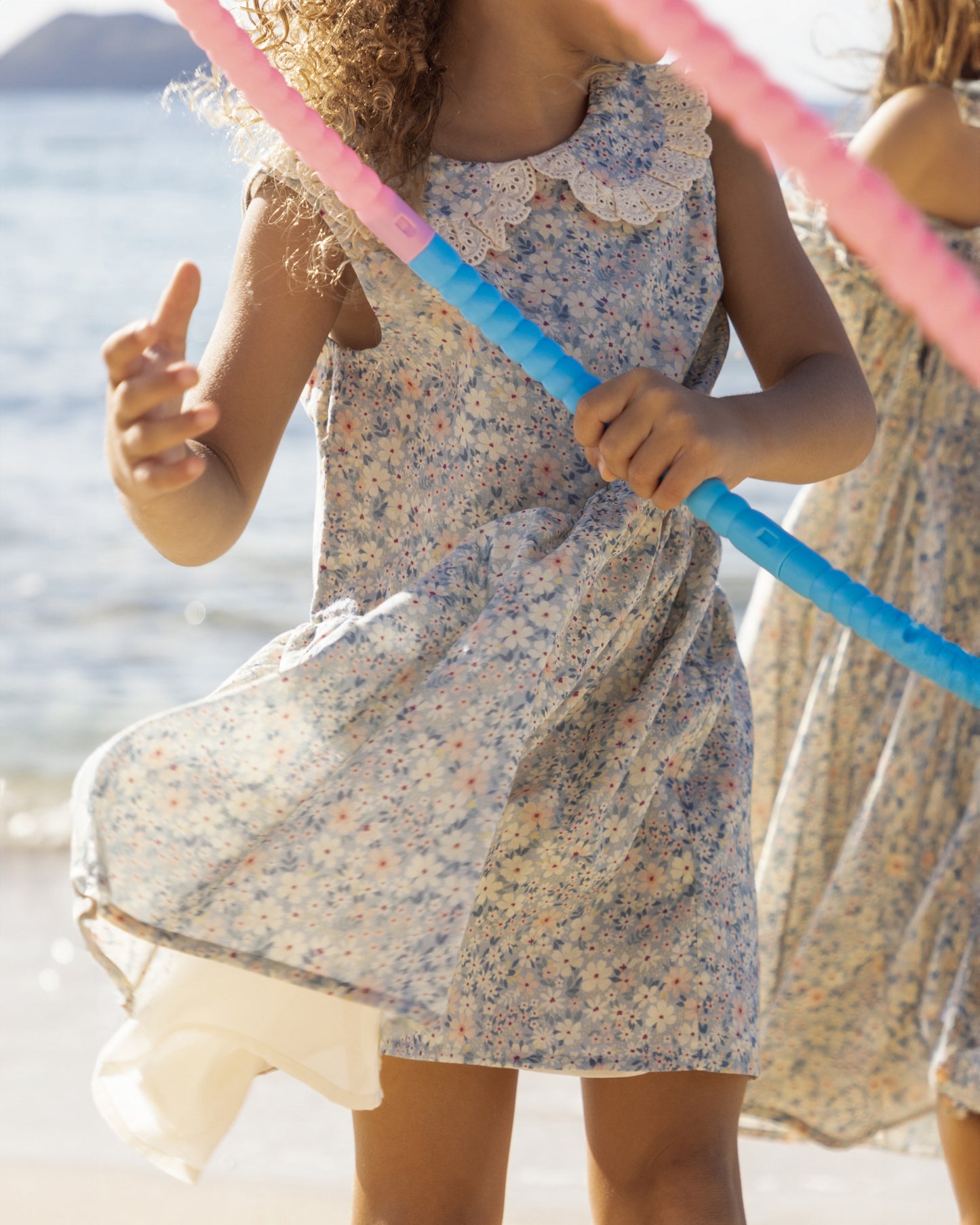 Early Sunday, LYS Dress in Amelia print, made from Printed Cotton Cambric fabric, featuring flattering fit with delicate finishes, combining style and functionality for an effortlessly elegant look, shown in a outdoor shot of model wearing it