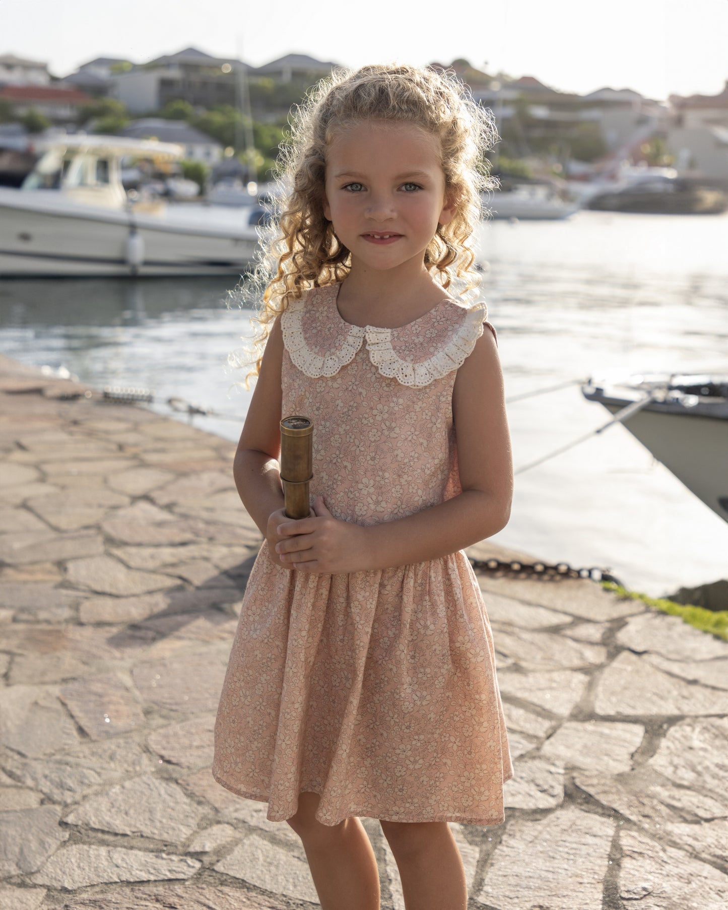 Early Sunday, LYS Dress in Garden Flowers print, made from Printed Cotton Cambric fabric, featuring flattering fit with delicate finishes, combining style and functionality for an effortlessly elegant look, shown in a front view of model wearing it