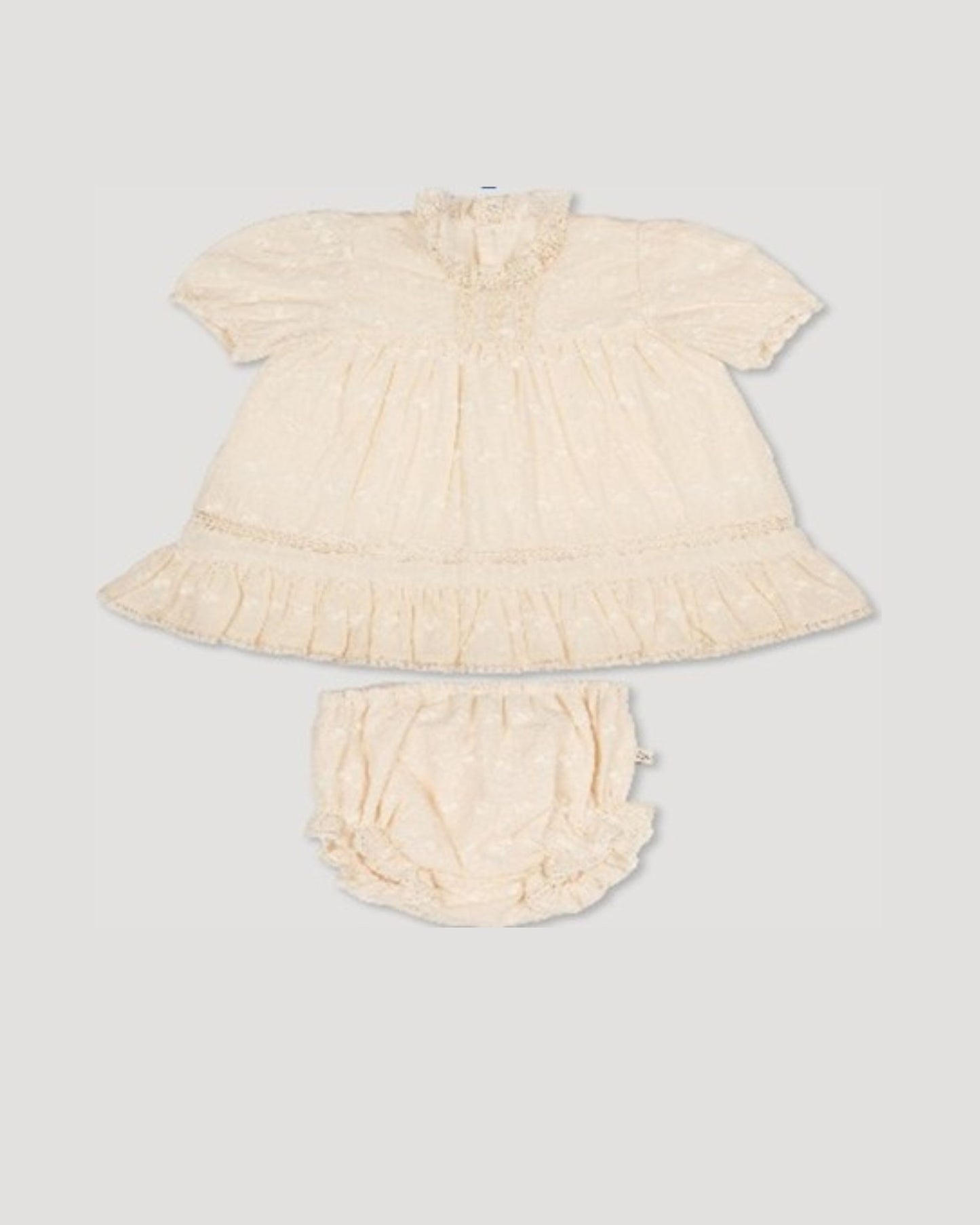 Early Sunday, Mae Baby Dress & Bloomer in Hazelnut Cream color, made from All-over Embroidered Cotton Cambric fabric, featuring lace yolk with beautiful embroidery, shown in a front flat-lay view