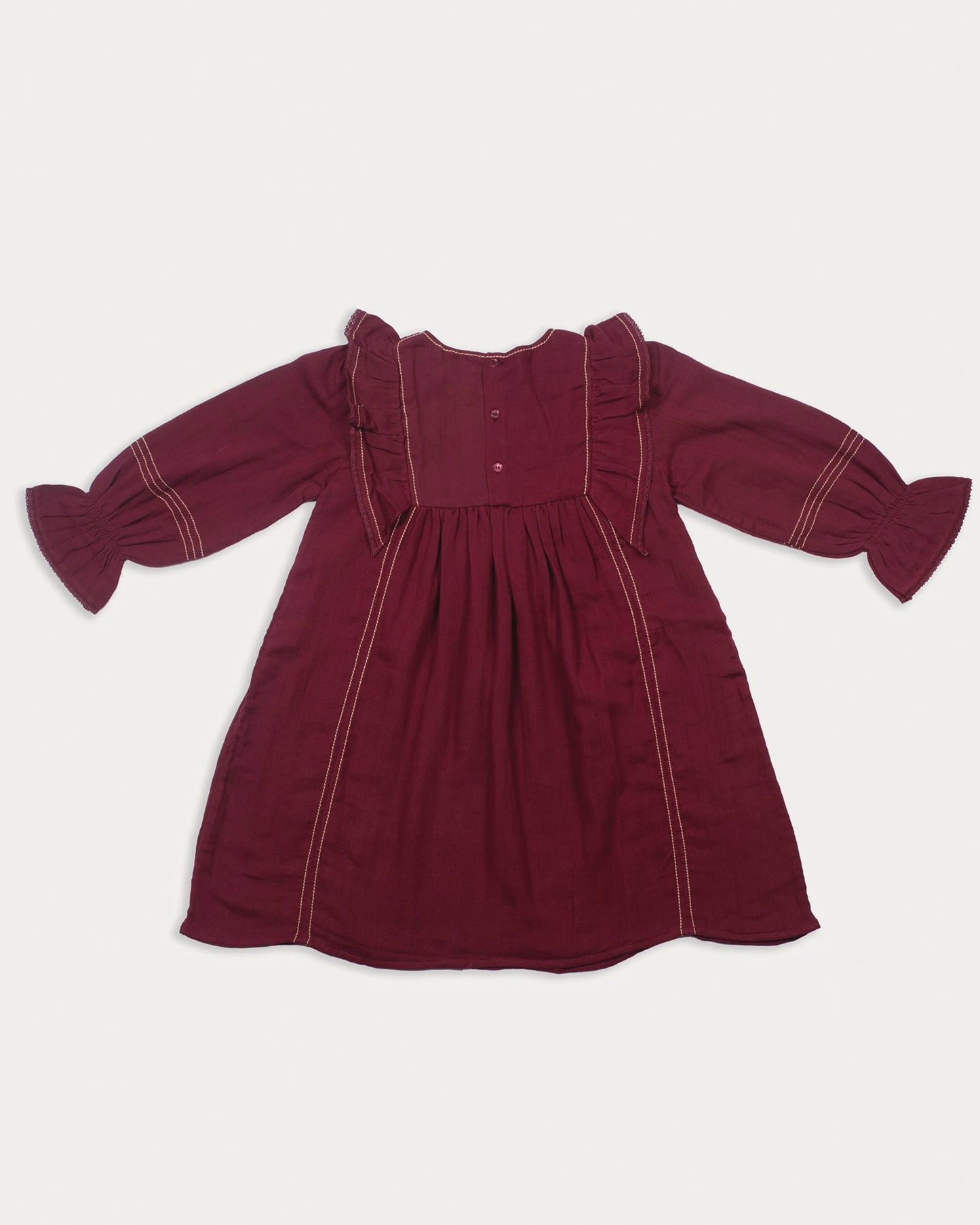 Early Sunday, Margot Dress in Plum, made from Cotton Double Gauze fabric, featuring classic silhouette with ruffle detailing around the sleeves, shown in a back flat-lay view