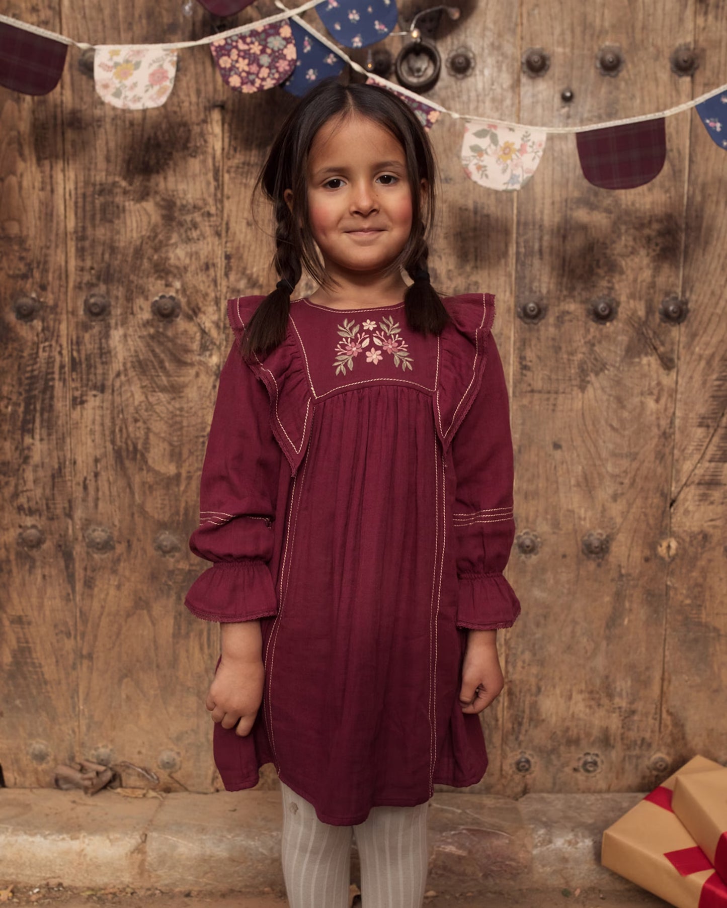 Early Sunday, Margot Dress in Plum, made from Cotton Double Gauze fabric, featuring classic silhouette with ruffle detailing around the sleeves, shown in a front view of model wearing it
