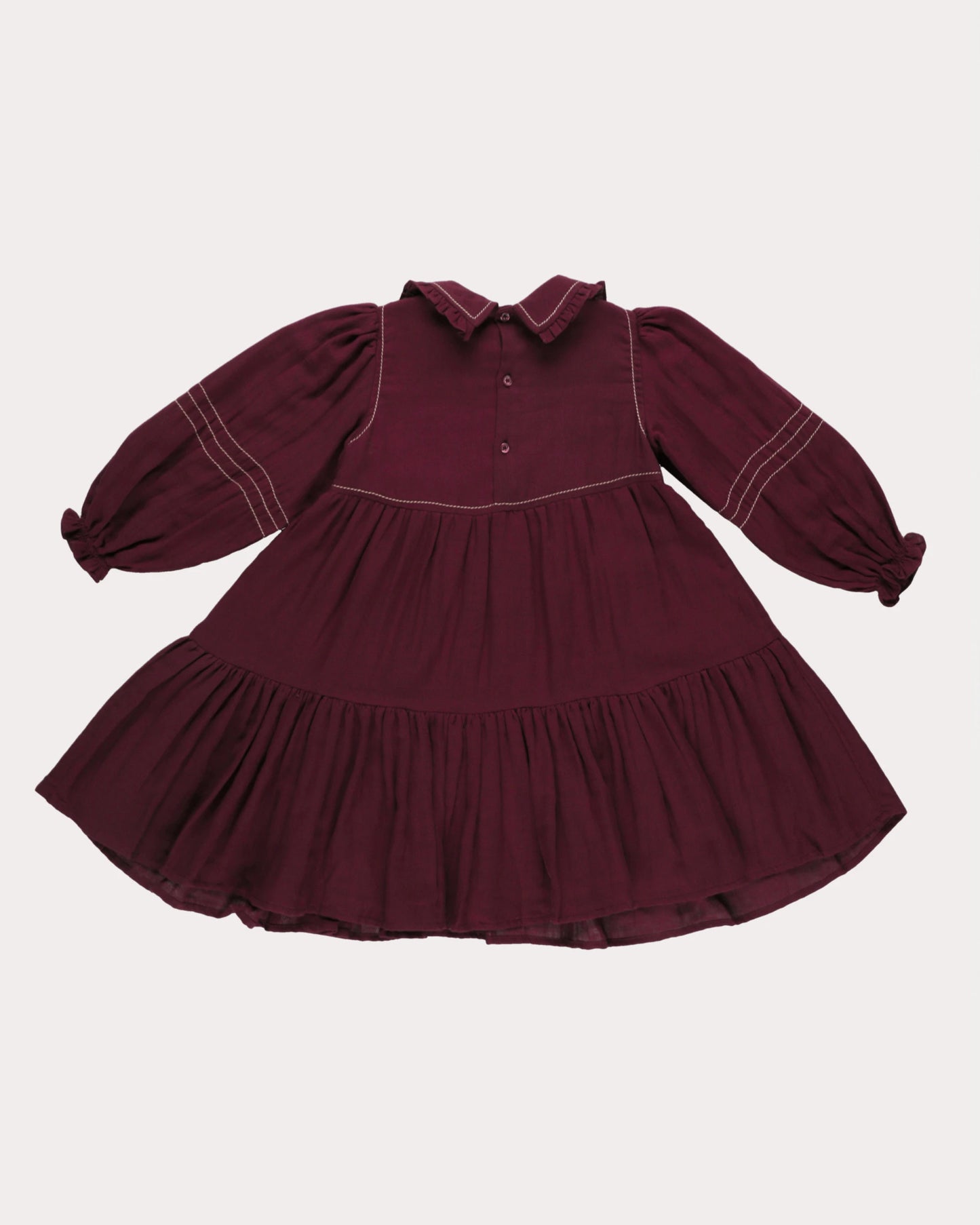 Early Sunday, Marguerite Dress in Plum, made from Cotton Double Gauze fabric, featuring floral embroidery with frilled Peter Pan collar, shown in a back flat-lay view