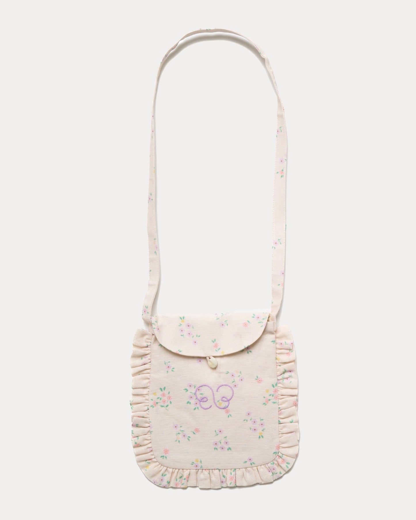 Early Sunday, Miss Sunday Sling in Painted Bouquet print, made from 70% Cotton, 30% Linen fabric, featuring a frill detailed sling purse with flap closure, shown in a front flat-lay view