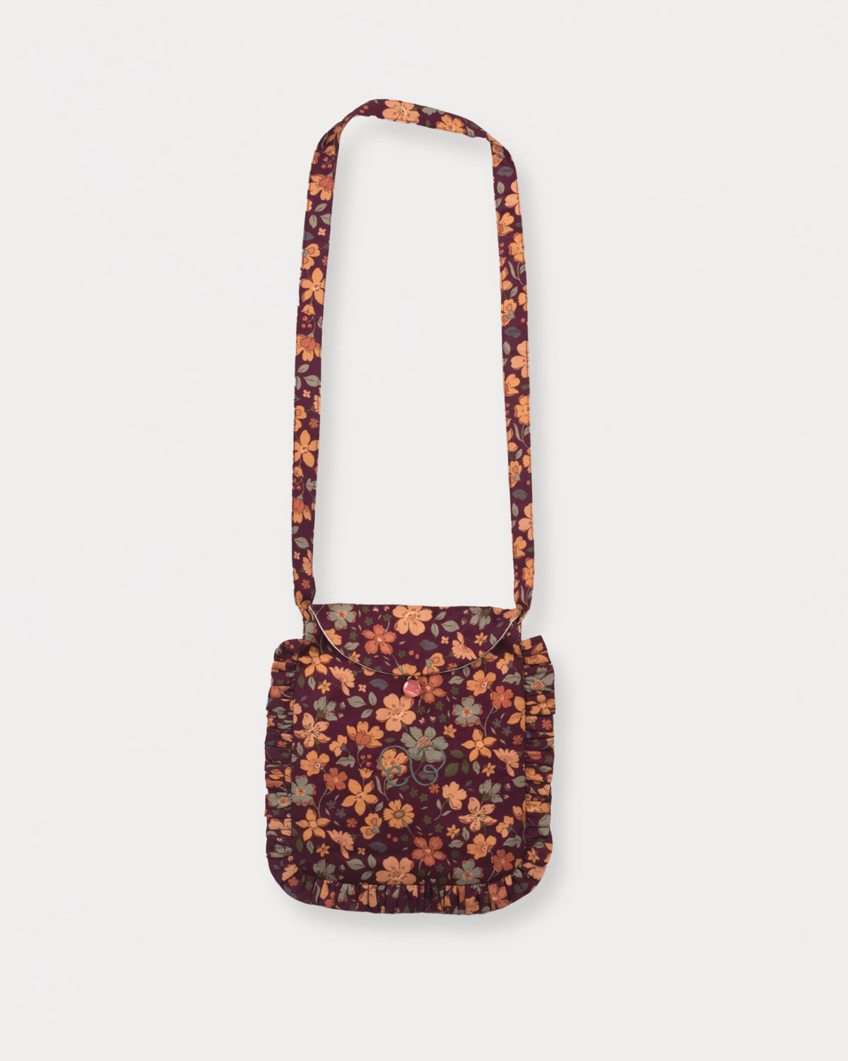 Early Sunday, Miss Sunday Sling in Garden Flowers Plum, made from Printed Cotton Satin fabric, featuring a frill detailed sling purse with flap closure, shown in a front flat-lay view