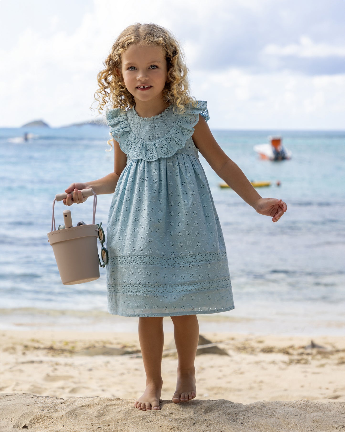 Early Sunday, Natasha Dress in Sea Dream color, made from All-Over Eyelet Embroidered Cotton Schifflie fabric, featuring flattering fit with delicate finishes, combining style and functionality for an effortlessly elegant look, shown in a front view of model wearing it