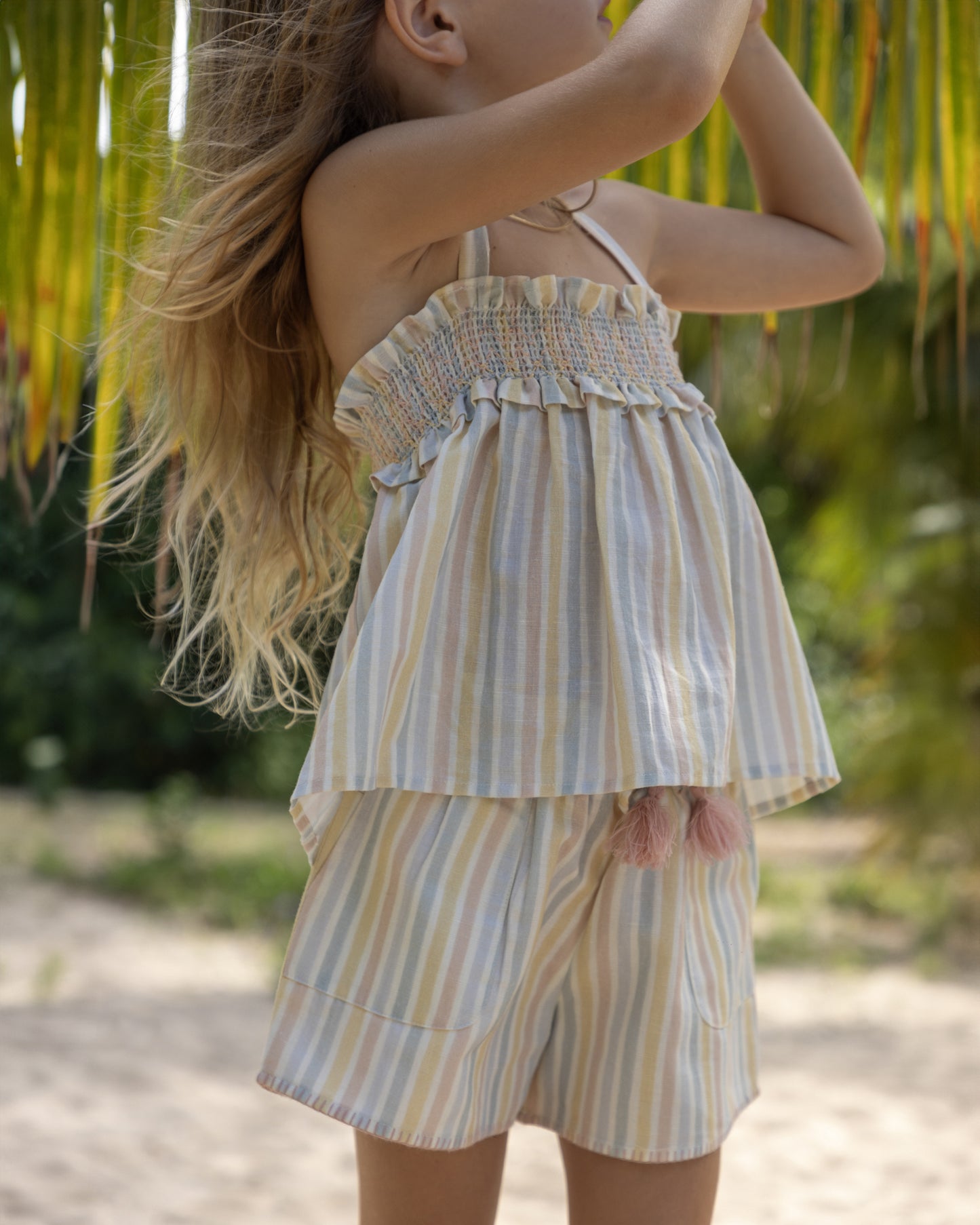 Early Sunday, Olivia Blouse & Roman Shorts in Summer Stripe, made from Printed canvas 70% Cotton 30% Linen fabric, featuring smocked bodice for a flexible fit, cross-back straps and elasticated waistband to move in ease, shown in a front view of model wearing it
