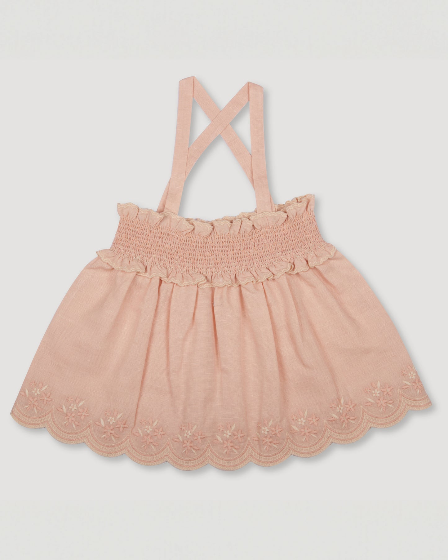 Early Sunday, Olivia Blouse in Pink Sand color, made from Canvas 70% Cotton 30% Linen fabric, featuring smocked bodice for a flexible fit, cross-back strap sand a flared hem, shown in a front flat lay view