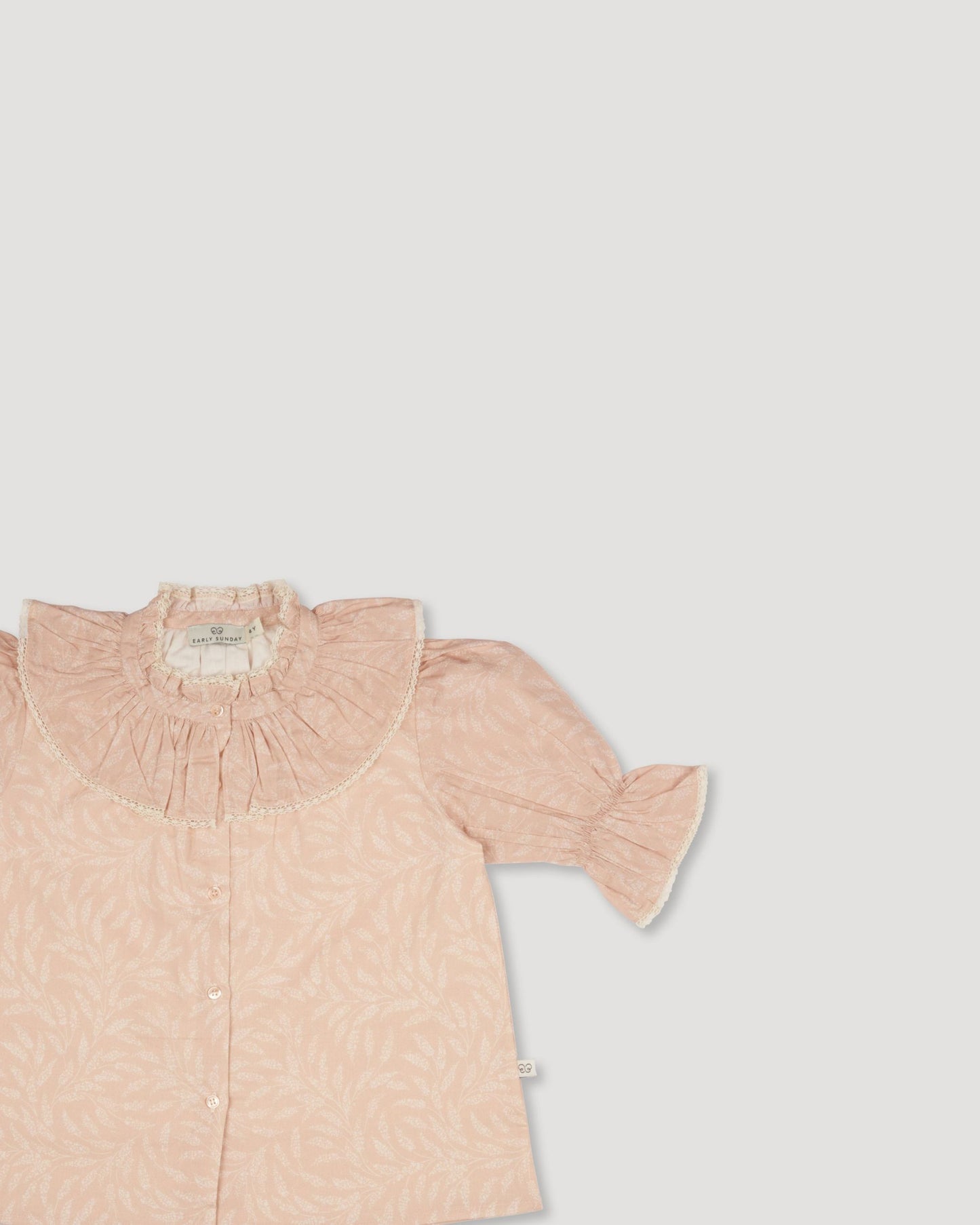 Early Sunday, Ophelie Blouse in Feather print, made from Printed Cotton Cambric fabric, featuring Comfort-first design with a playful silhouette and French seams, shown in a closeup flat-lay view