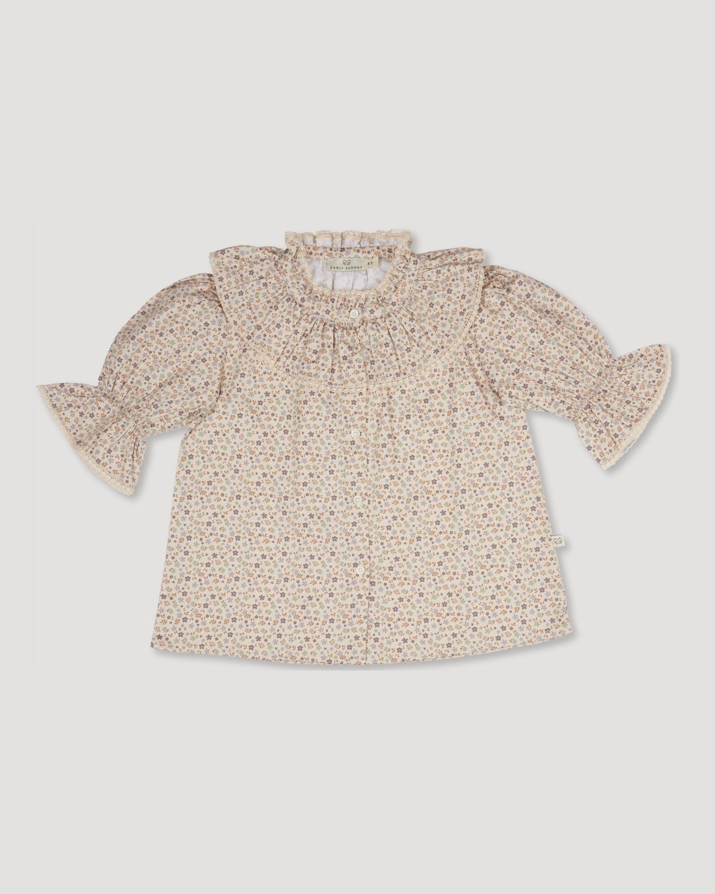 Early Sunday, Ophelie Blouse in Miny Flowers print, made from Printed Cotton Satin fabric, featuring Comfort-first design with a playful silhouette and French seams, shown in a front flat-lay view