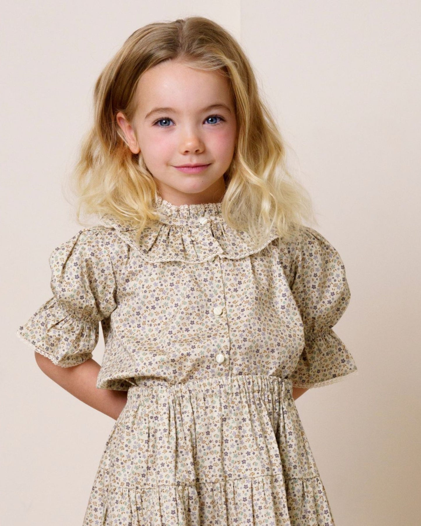 Early Sunday, Ophelie Blouse in Miny Flowers print, made from Printed Cotton Satin fabric, featuring Comfort-first design with a playful silhouette and French seams, shown in a front view of model wearing it