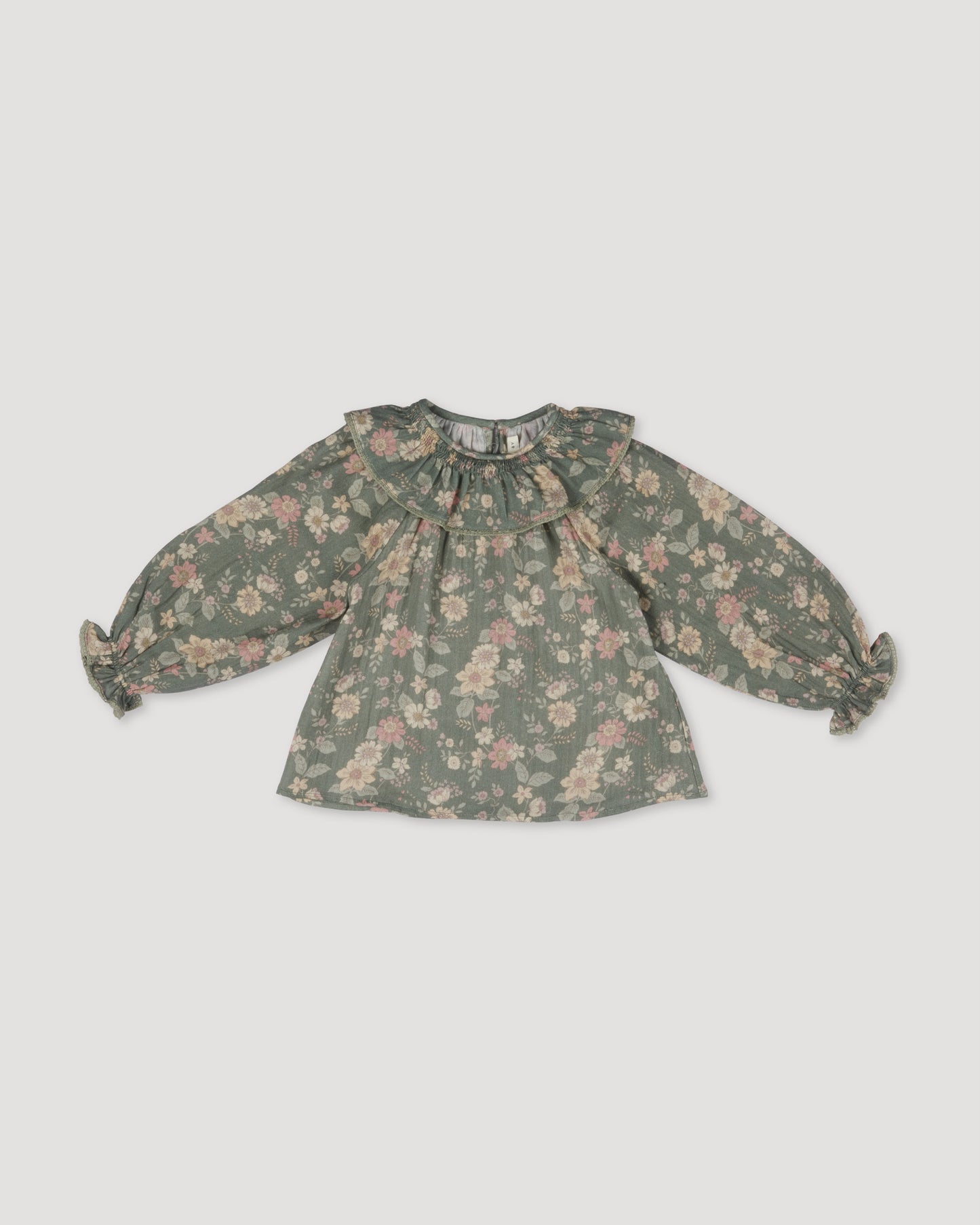 Early Sunday, Paloma Blouse in Autumn Bloom Soft Green, made from Printed Cotton Double Gauze fabric, featuring relaxed fit with a ruffle neckline, shown in a front flat-lay view