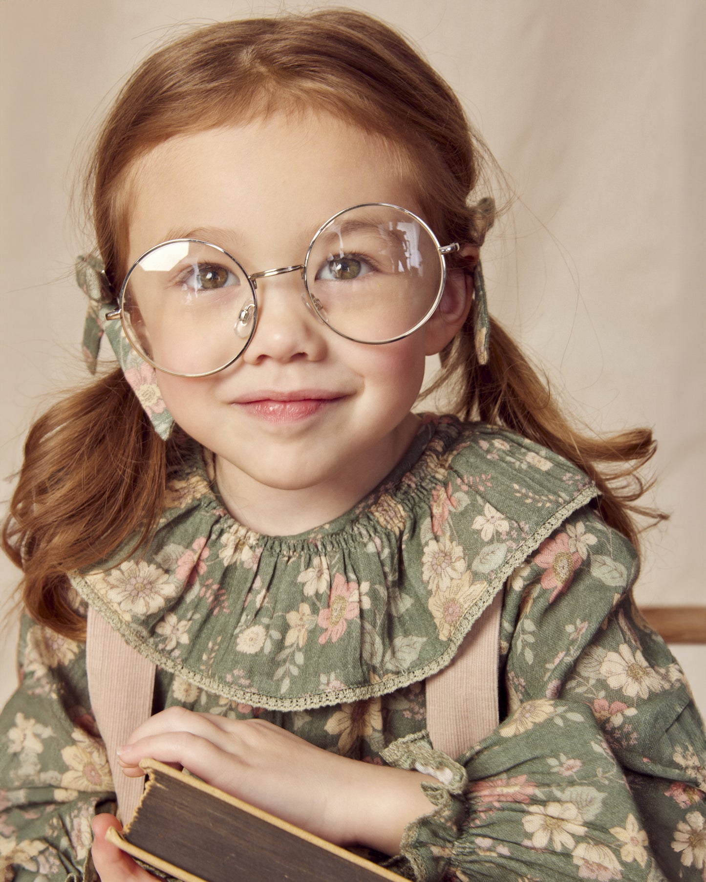 Early Sunday, Paloma Blouse in Autumn Bloom Soft Green, made from Printed Cotton Double Gauze fabric, featuring relaxed fit with a ruffle neckline, shown in a close-up shot of a model wearing it during a studio shoot