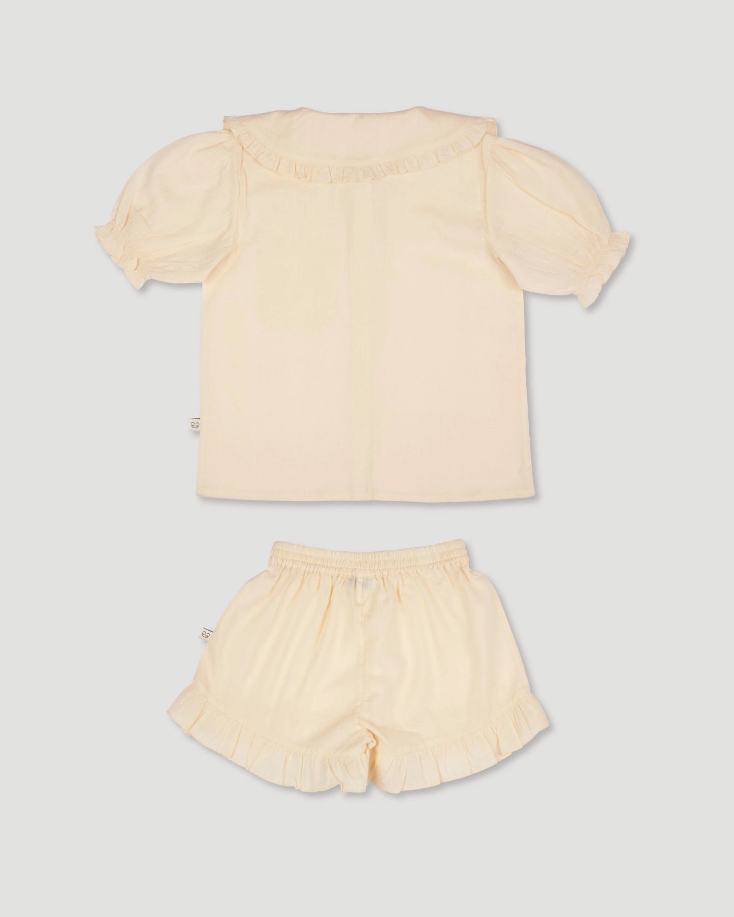 Early Sunday, Peggy Pyjama Set in Hazelnut Cream, made from Dyed Cotton Swiss Dobby Tiny Dots fabric, featuring Button-down shirt with classic tailoring, subtle gathers, and gentle volume, shown in a back flat-lay view