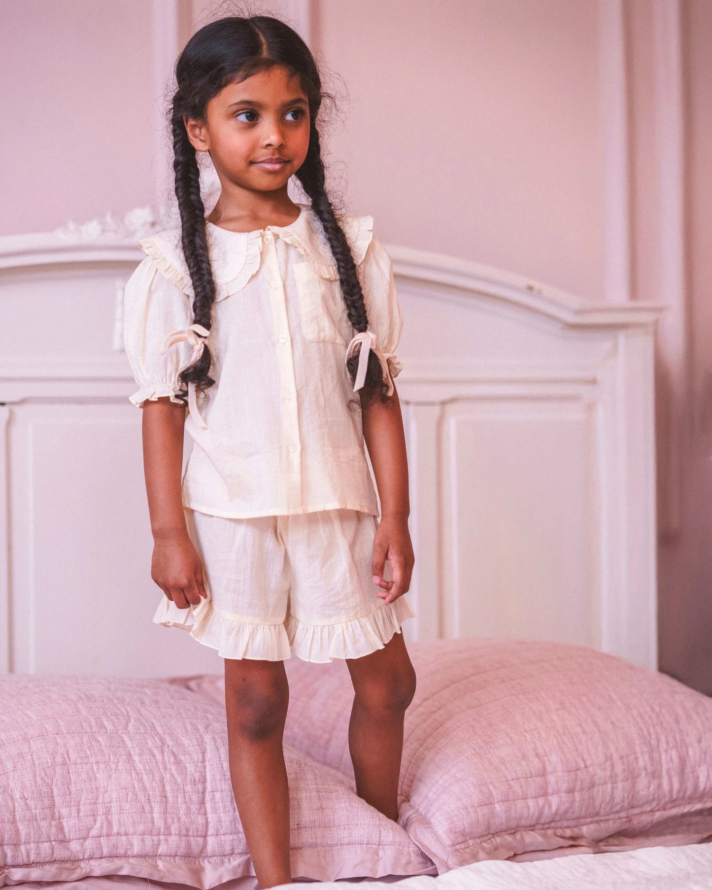 Early Sunday, Peggy Pyjama Set in Hazelnut Cream, made from Dyed Cotton Swiss Dobby Tiny Dots fabric, featuring Button-down shirt with classic tailoring, subtle gathers, and gentle volume, shown in a front view of model wearing it