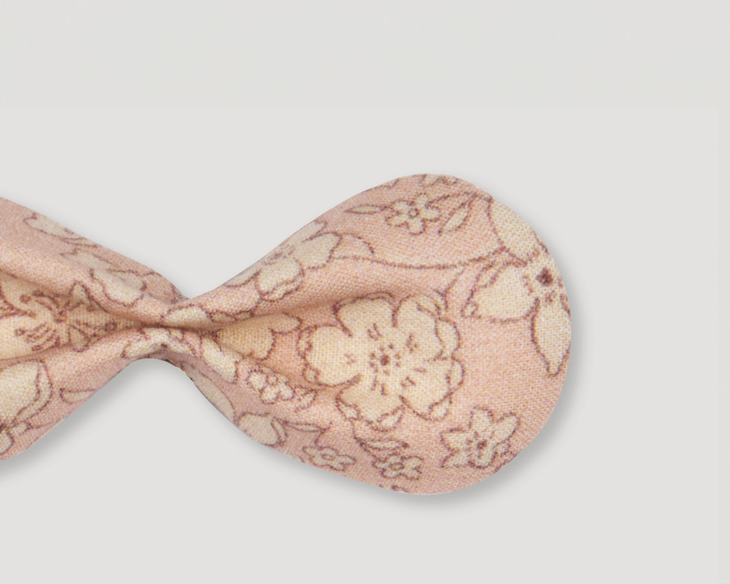 Early Sunday, Penelope Alligator Clip in Garden flower print, made from Printed Cotton Cambric fabric, featuring a bow design on an alligator clip with a secure fit, shown in a closeup flat-lay view