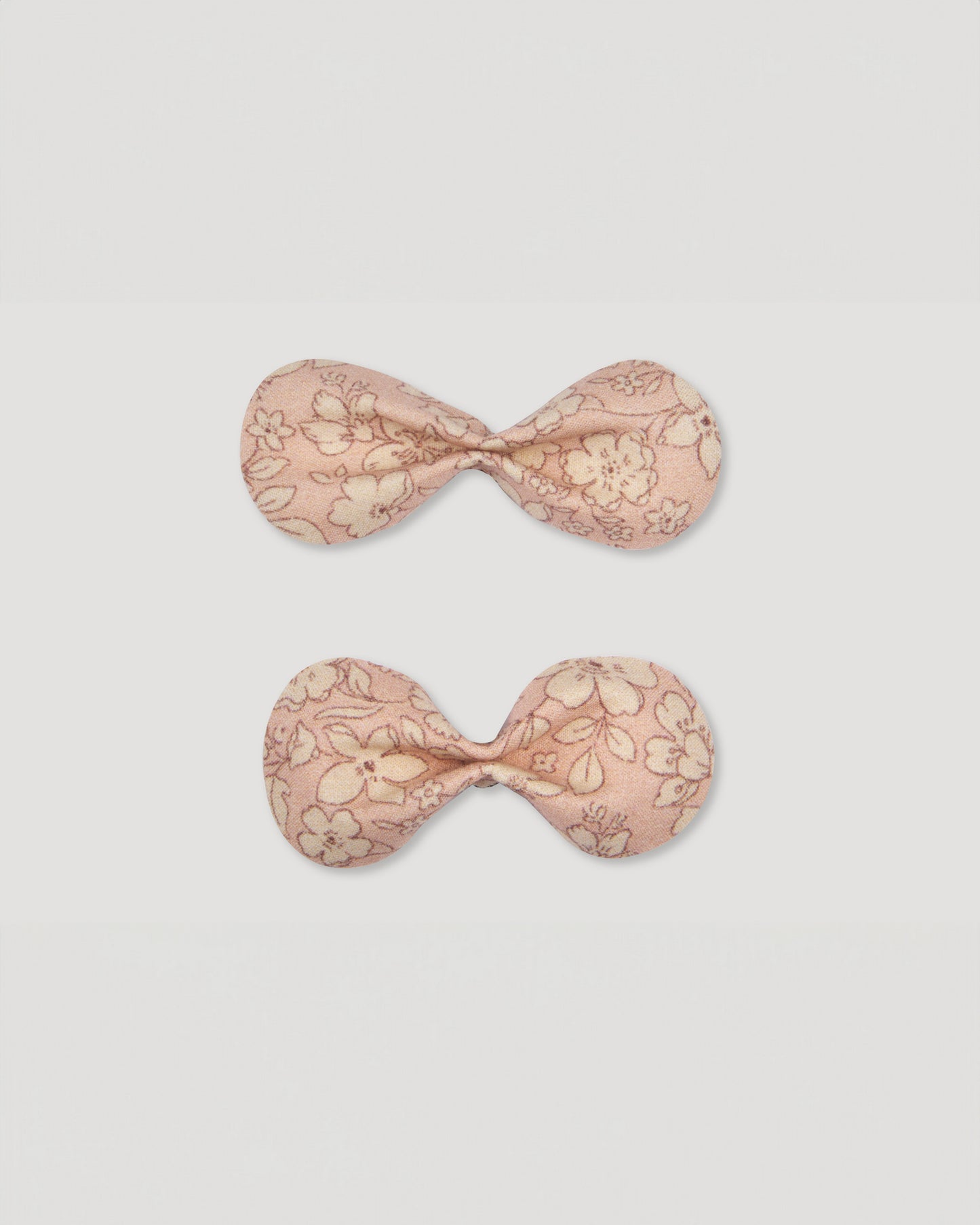 Early Sunday, Penelope Alligator Clip in Garden flower print, made from Printed Cotton Cambric fabric, featuring a bow design on an alligator clip with a secure fit, shown in a front flat-lay view