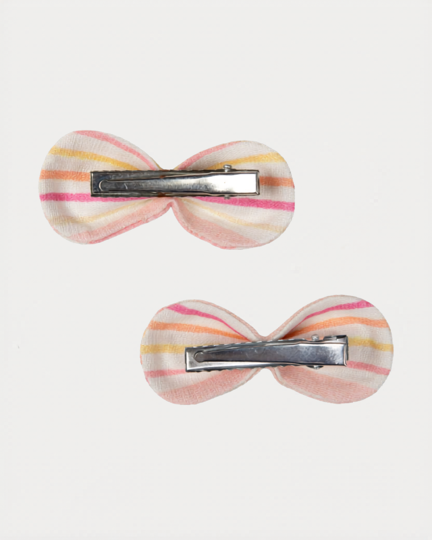 Early Sunday, Penelope Clip in Pink Stripes print, made from Printed 70% Cotton, 30% Linen fabric, featuring a set of two bow clips with a secure fit, shown in a back flat-lay view