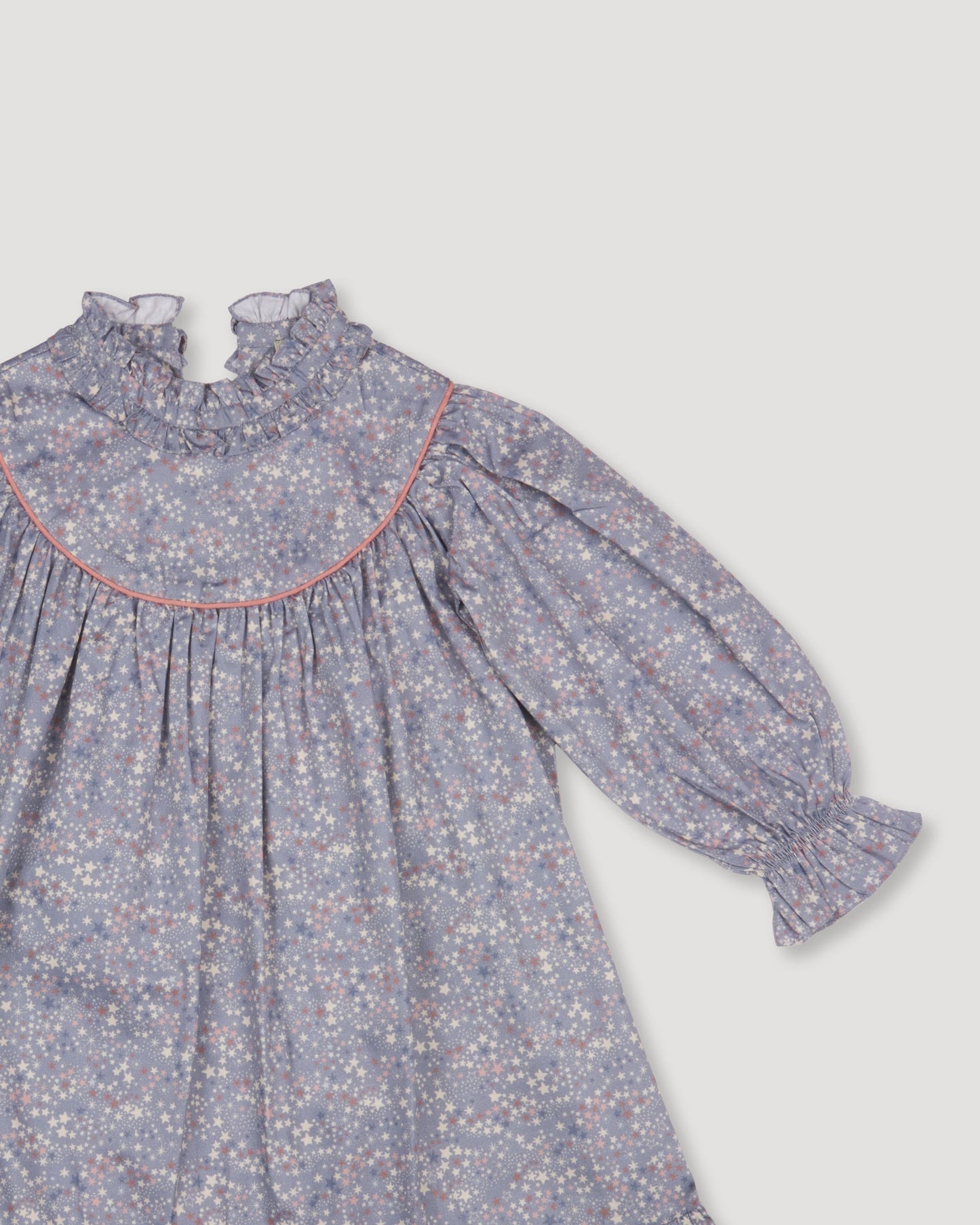 Early Sunday, Penelope Dress in Celestial print, made from Printed Cotton Satin fabric, featuring Hand-embroidered floral motifs, shown in a closeup flat-lay view